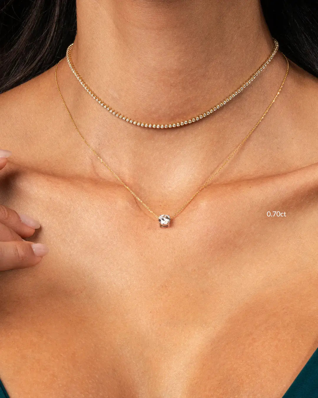 Elegant woman wearing a floating diamond necklace with a round diamond and a delicate gold chain.