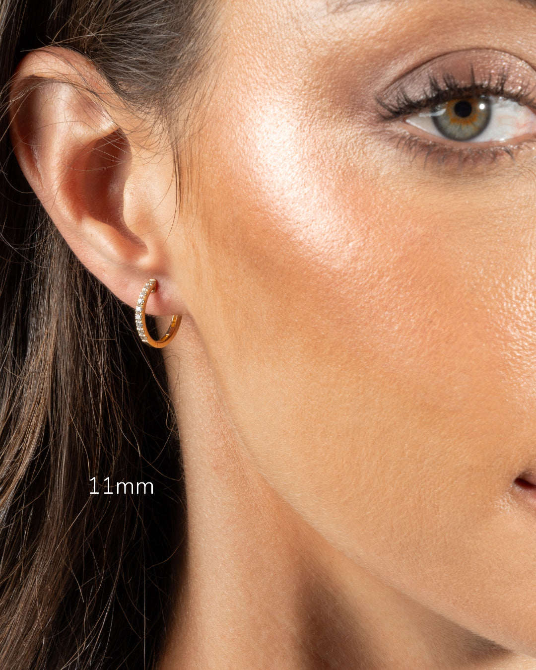 Model wearing 11mm diamond hoop earring showcasing elegance and sparkle in natural light.