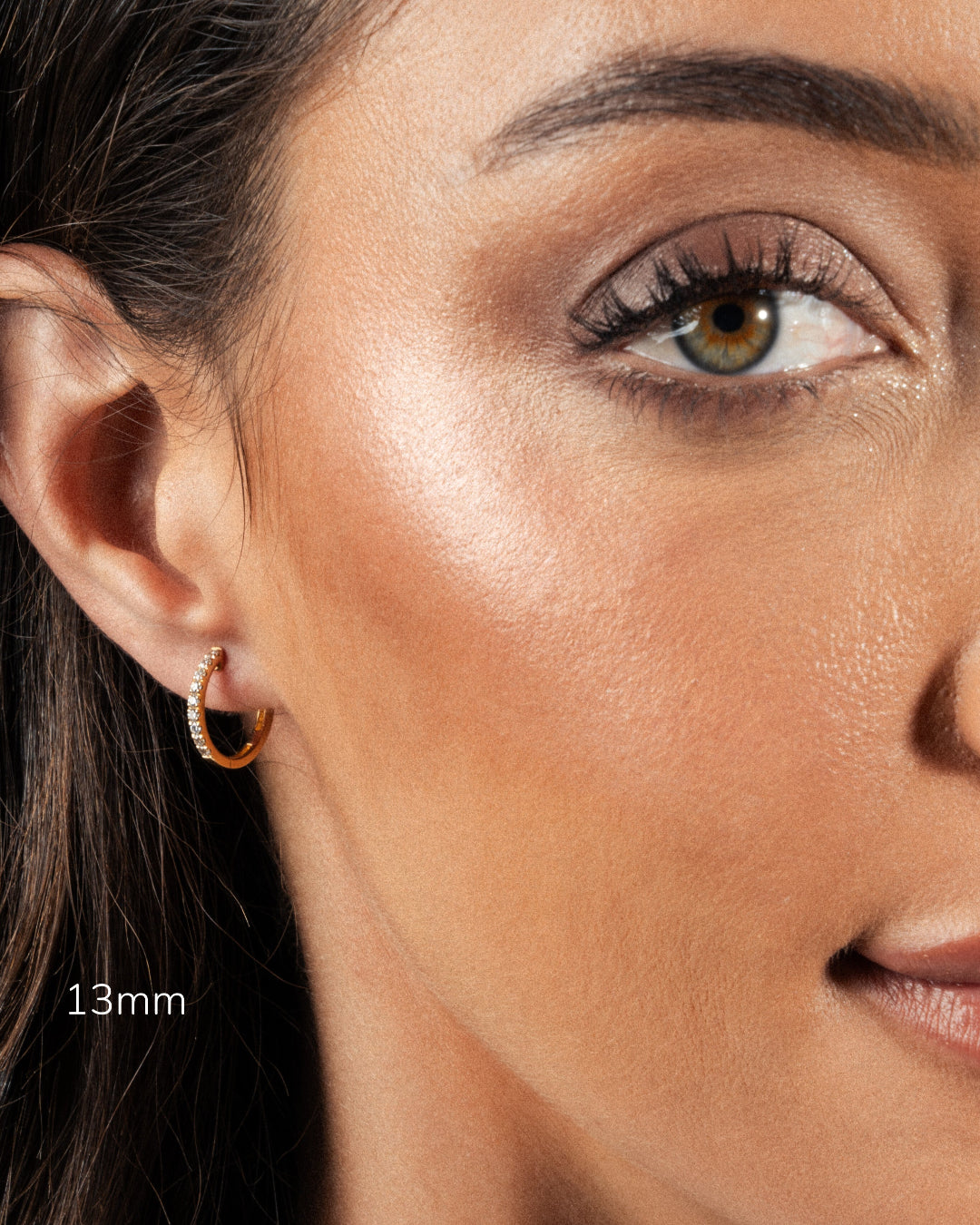 Close-up of model wearing 13mm diamond hoop earring, showcasing elegance and brilliance.