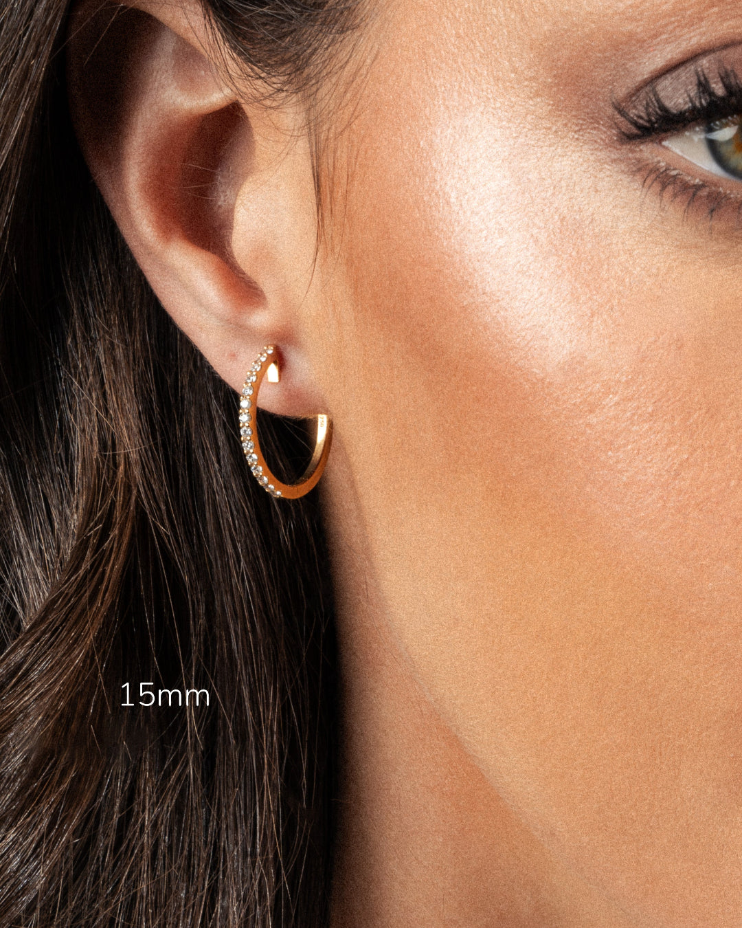 Close-up of a model wearing 15mm diamond hoop earring, showcasing its sparkle and elegance.