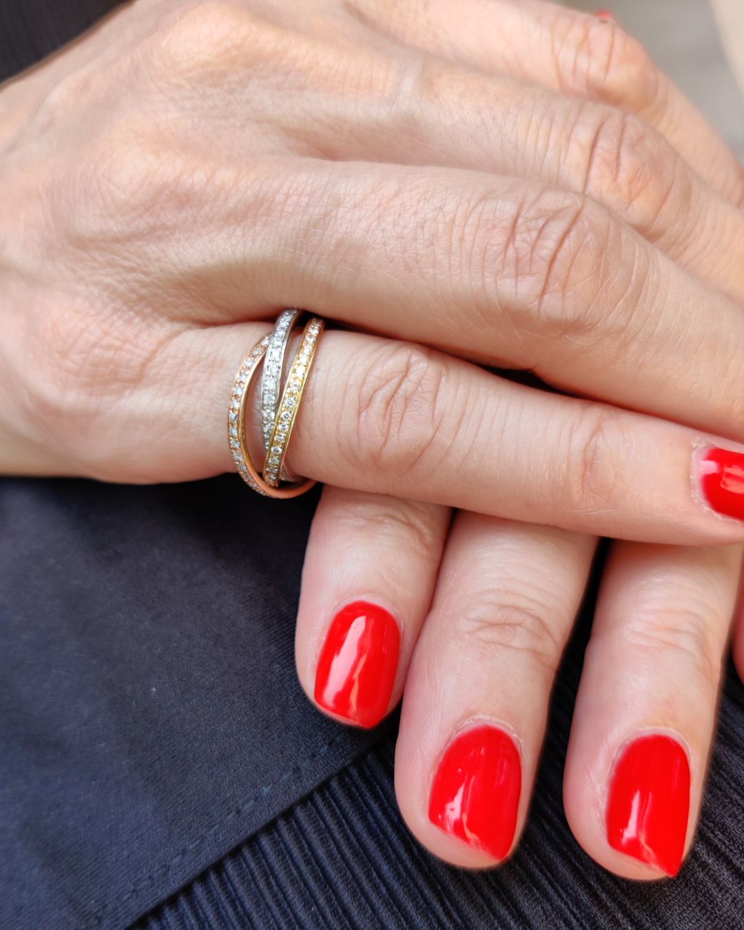 Model wearing grace diamond ring three rows of diamonds in 18ct white, rose, and yellow gold