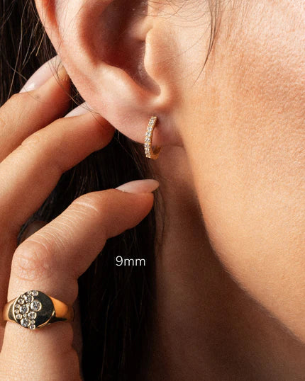 Diamond hoop earring displayed on model's ear, showcasing the elegant 9mm size and sparkling brilliance.