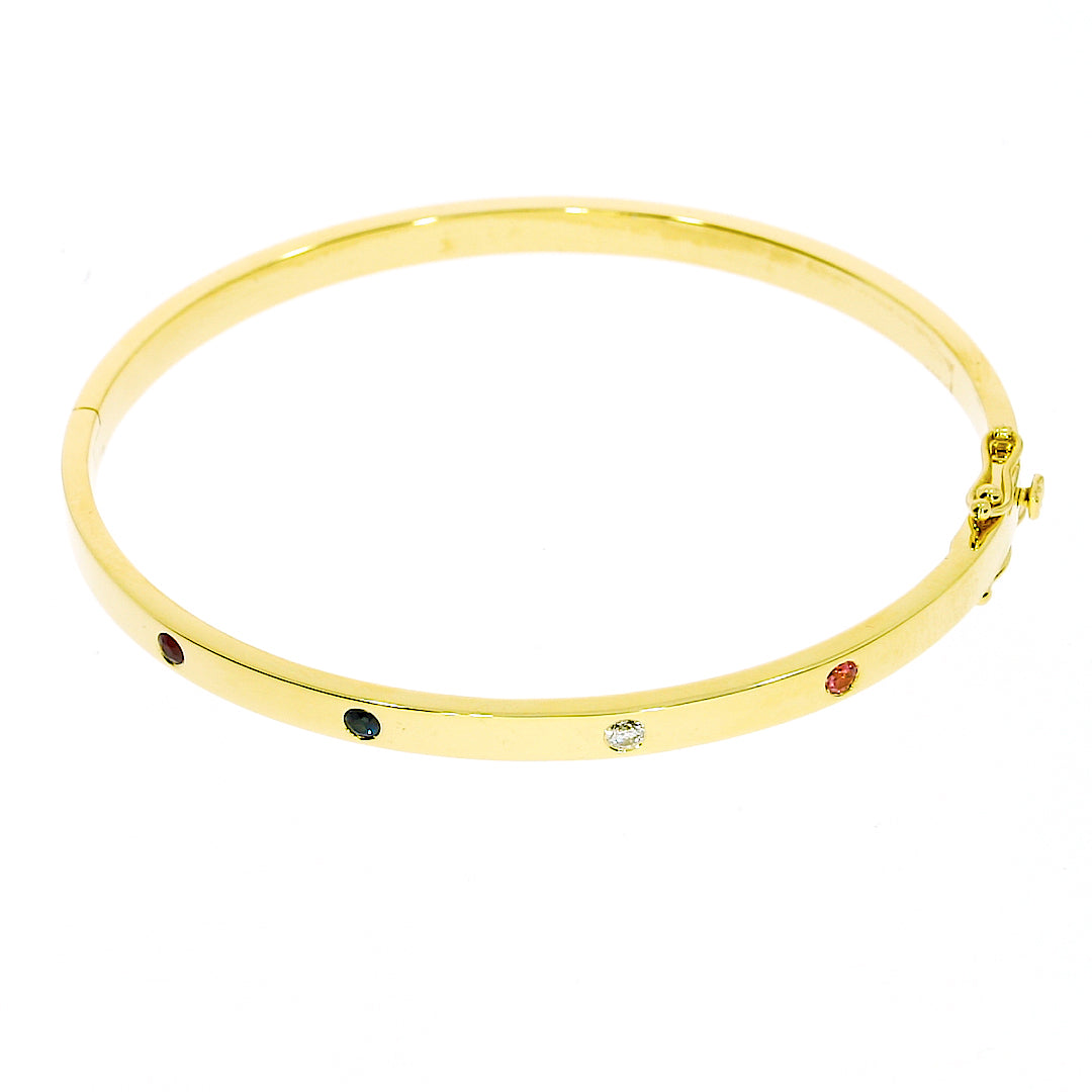 Elegant birthstone bangle in solid 18ct gold featuring four vibrant round brilliant cut birthstones.