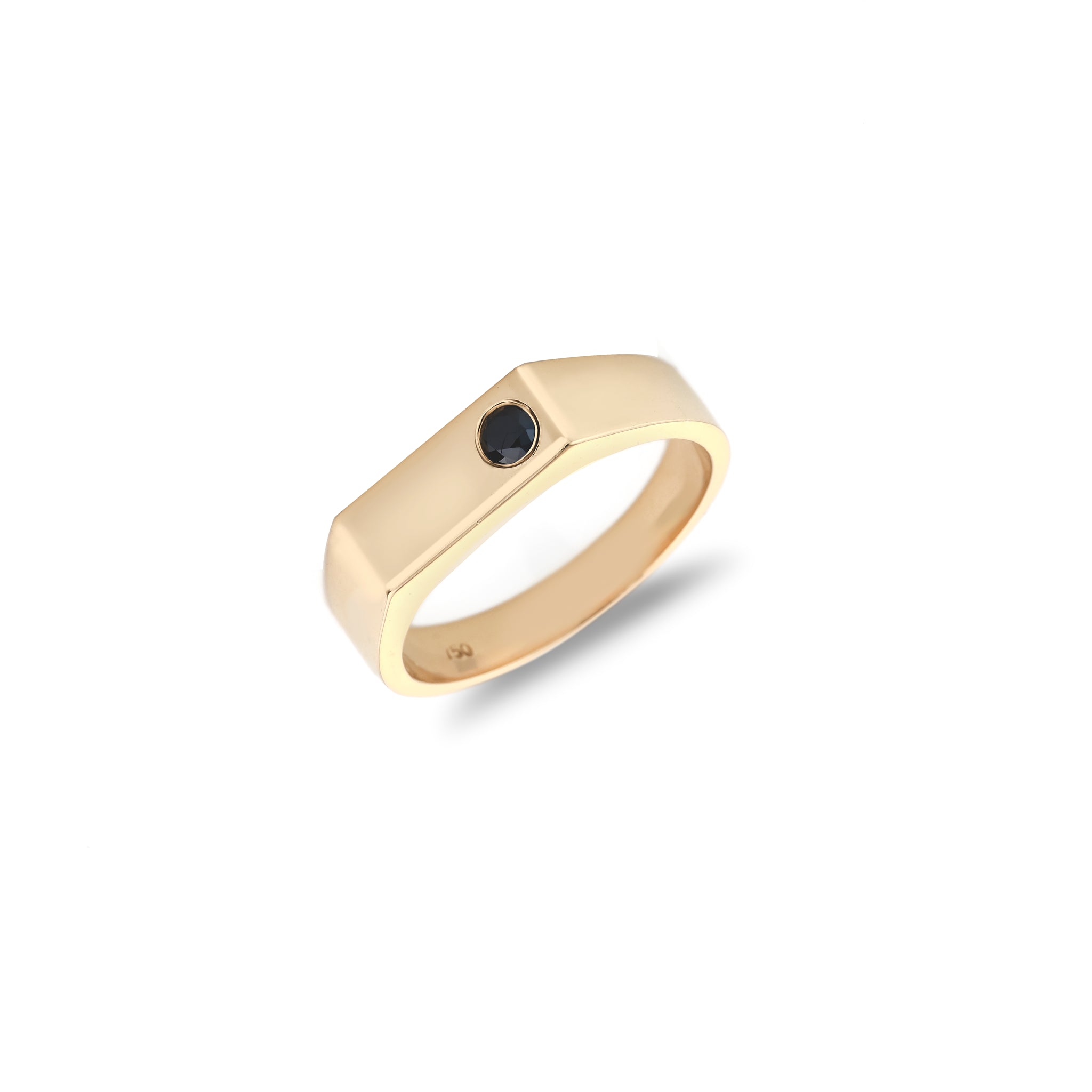 Gold ring with a black gemstone on a white background