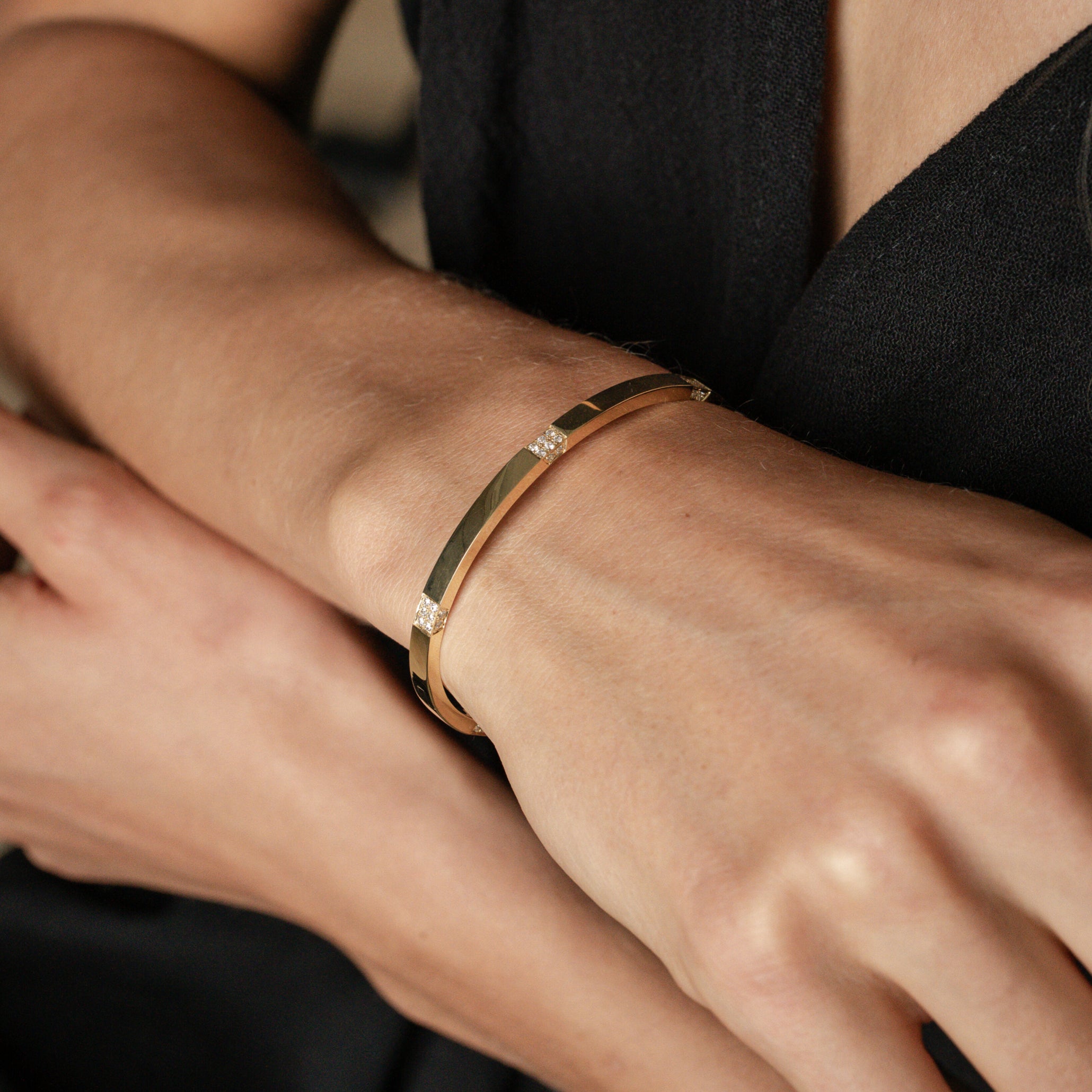 Luxury gold bangle adorned with diamonds, showcasing a sleek design for an elegant stacked jewellery look.
