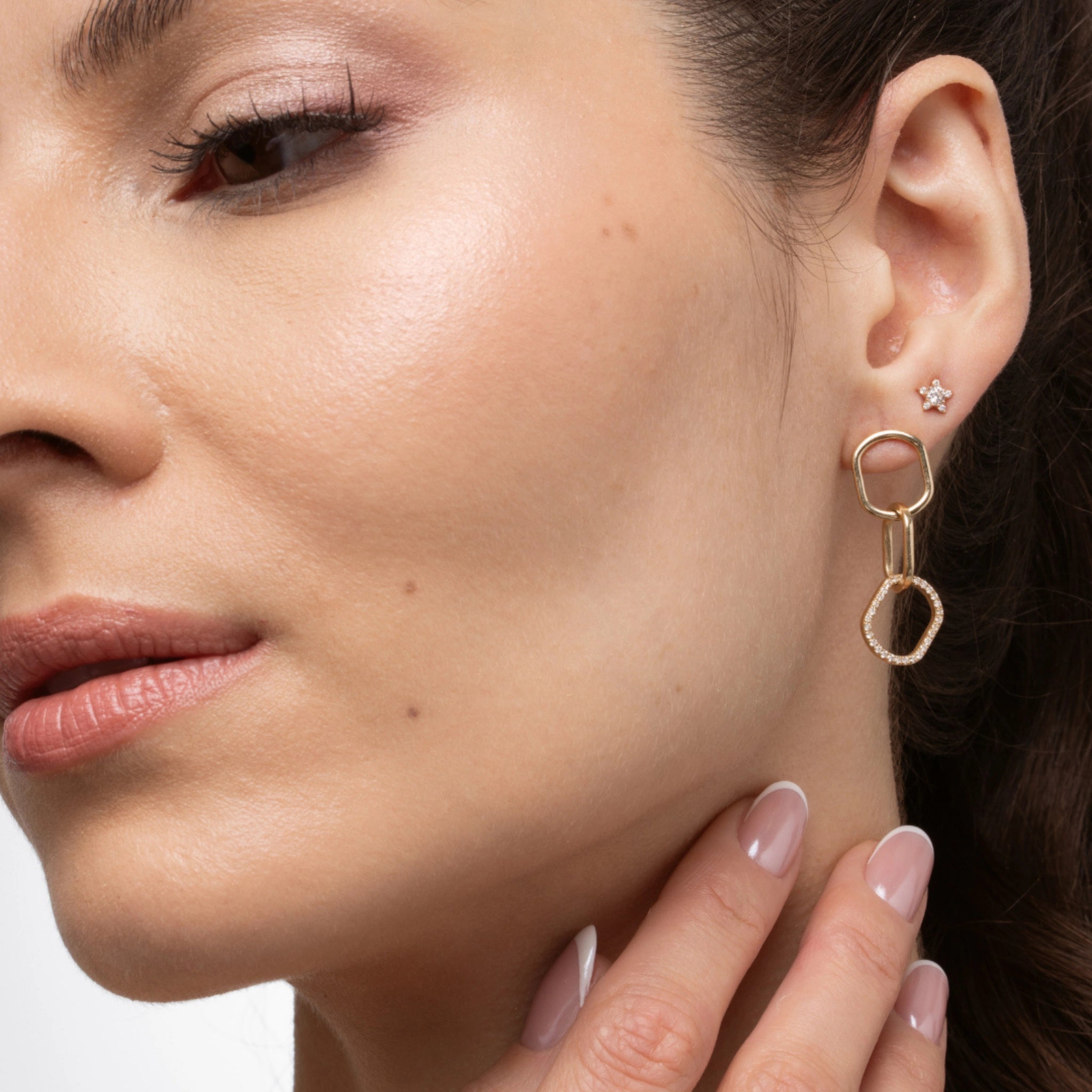Model showcasing chain link diamond earrings with interlocking links in solid 18ct gold and sparkling certified diamond accents.
