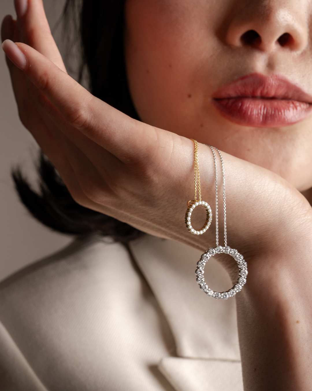 Circle Of Life Necklace - Small showcased on model's hand, highlighting diamond detail and elegant design.