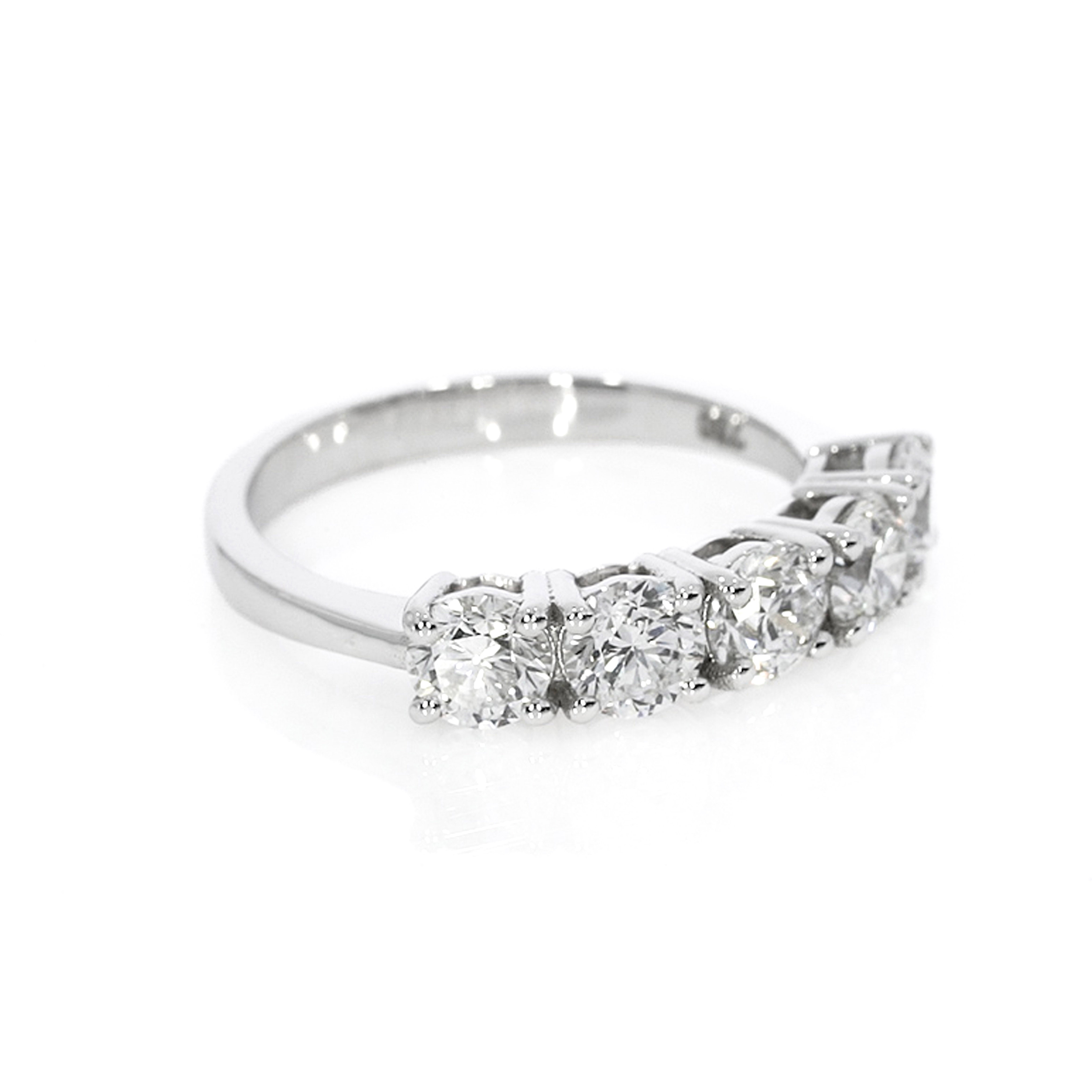Eternity ring with five round brilliant cut diamonds, set in a modern open basket setting for bright white sparkle