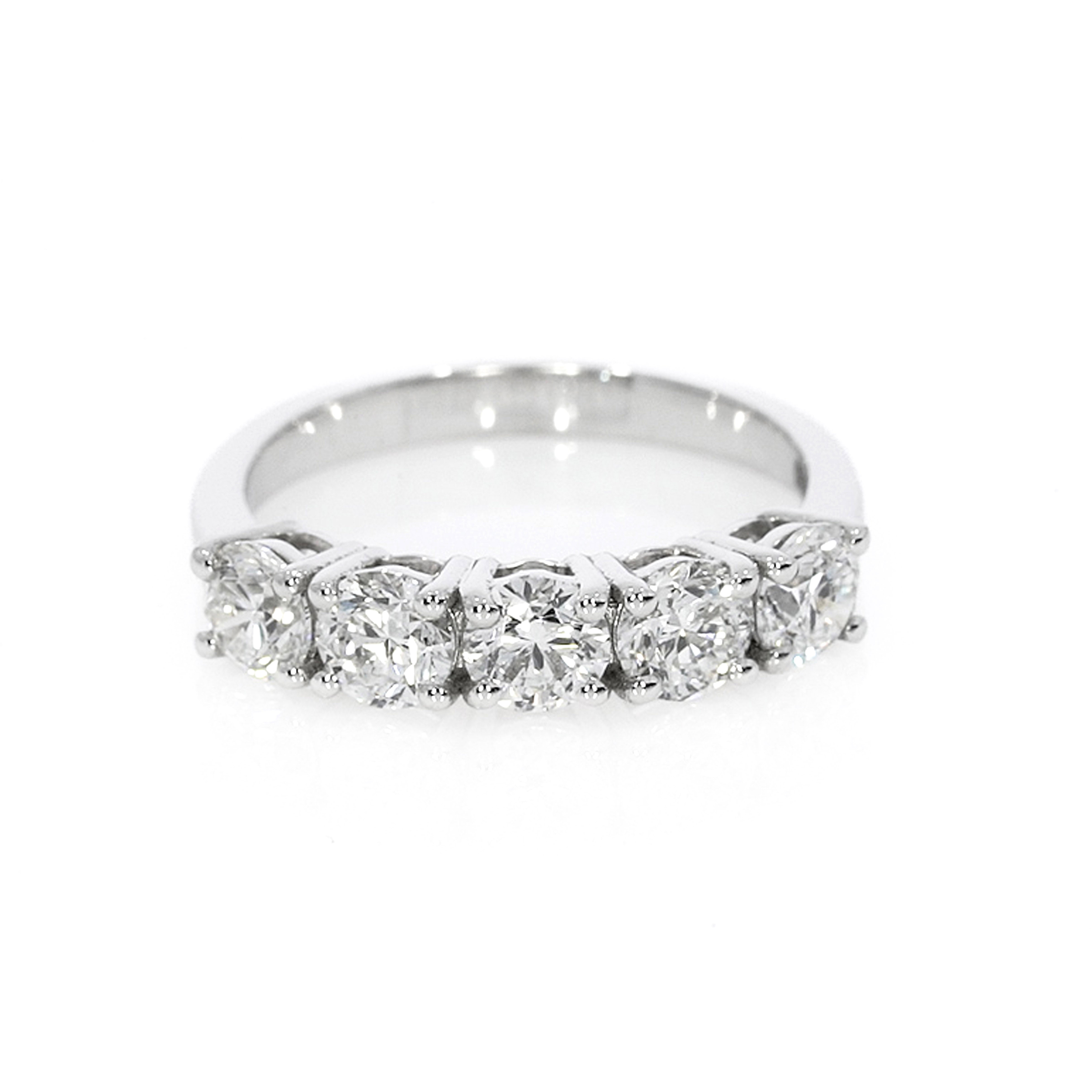 Timeless eternity ring with five round brilliant cut diamonds, set in a modern open basket setting for bright white sparkle