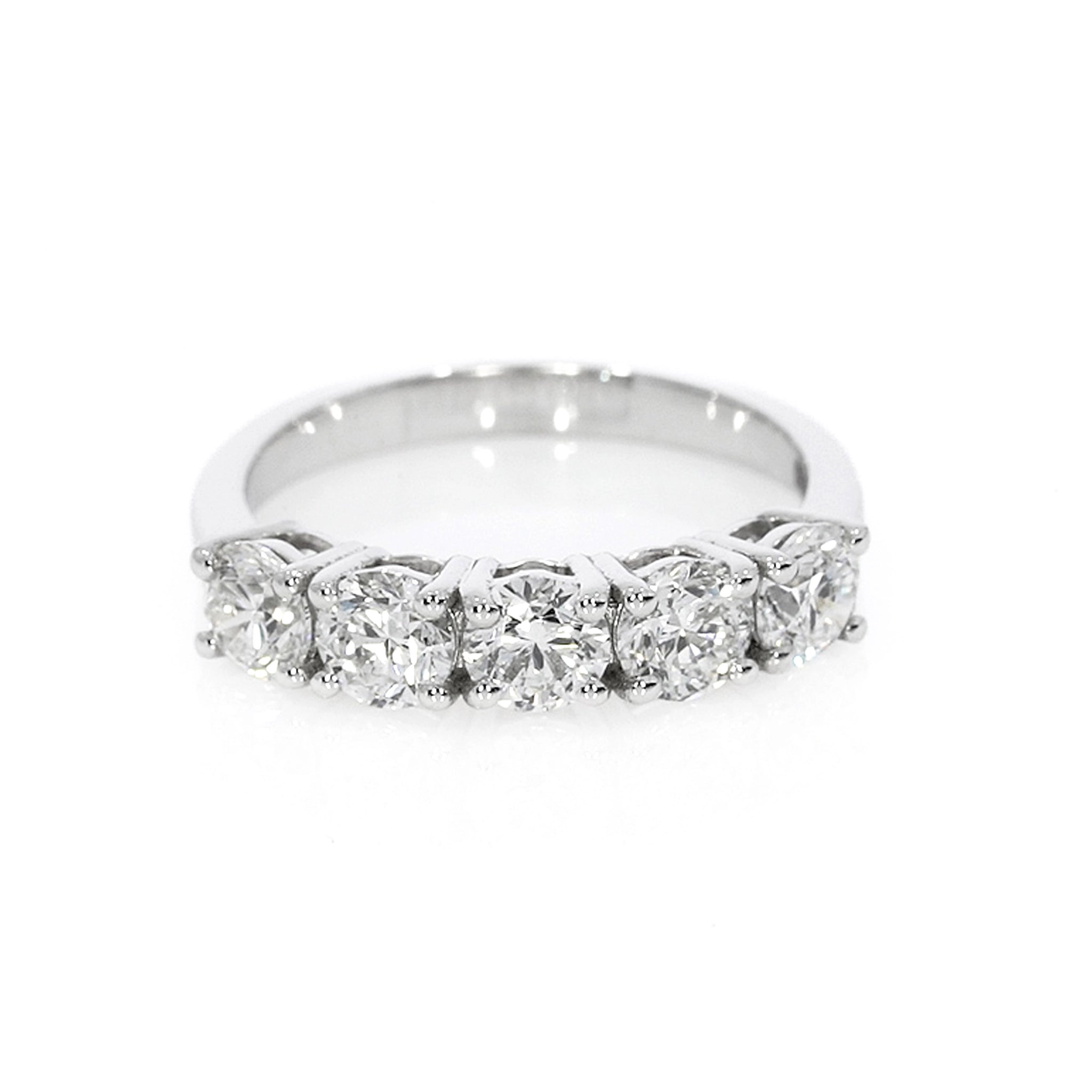 Timeless eternity ring with five round brilliant cut diamonds, set in a modern open basket setting for bright white sparkle