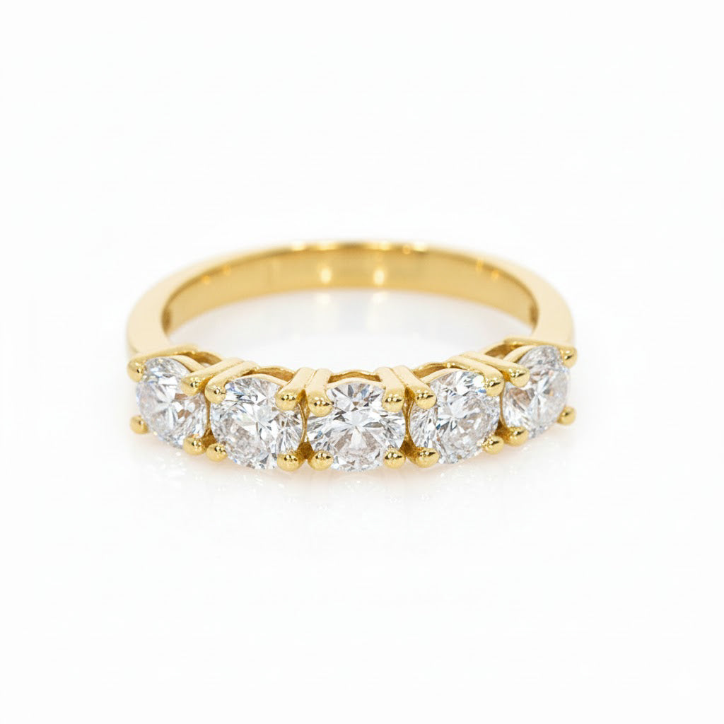 Five Stone Eternity Ring featuring five round brilliant cut diamonds set in yellow gold.