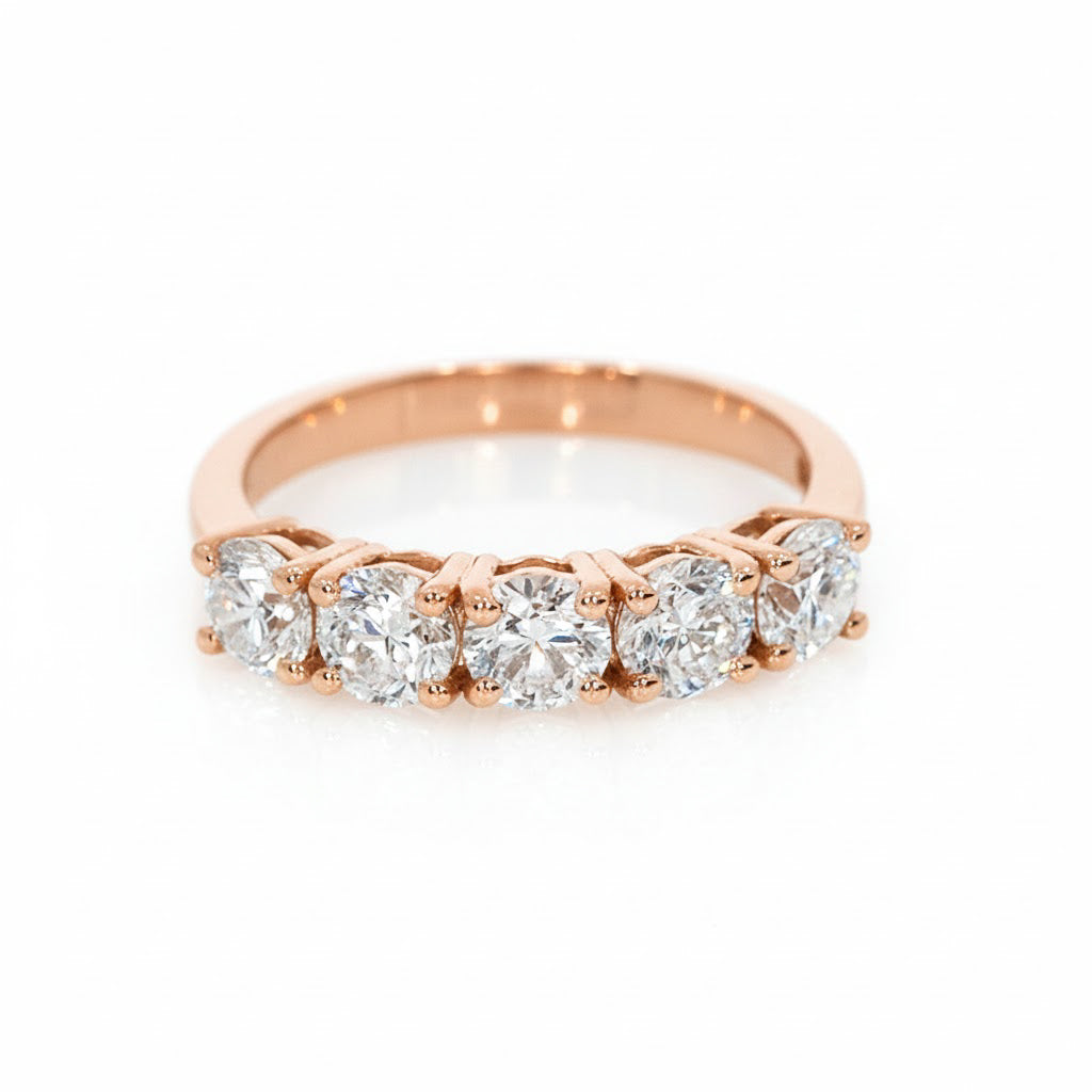 Rose gold ring with diamonds on a white background