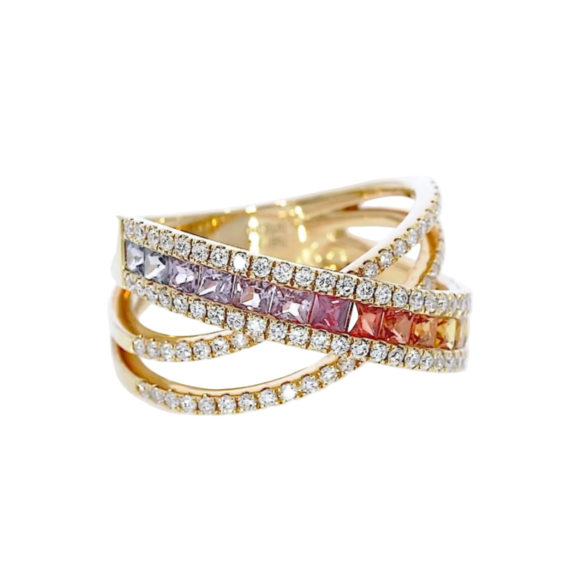 Criss cross ring featuring fifteen coloured sapphires in green to blue hues, and round brilliant diamonds, set in 18ct gold.