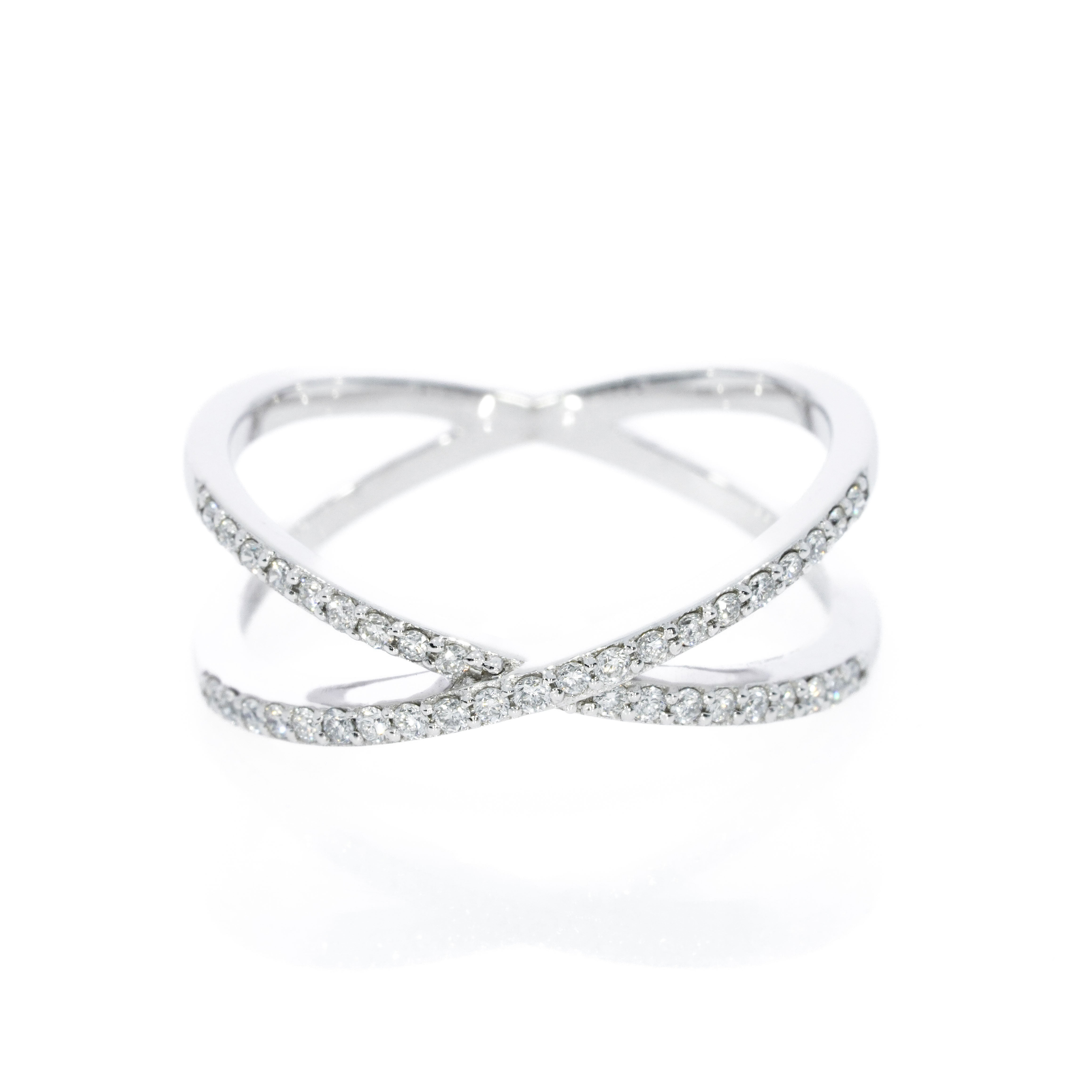 Criss-cross ring with 0.18cts of bright diamonds, in 18ct gold with stylish bands intersect for a sparkling look.