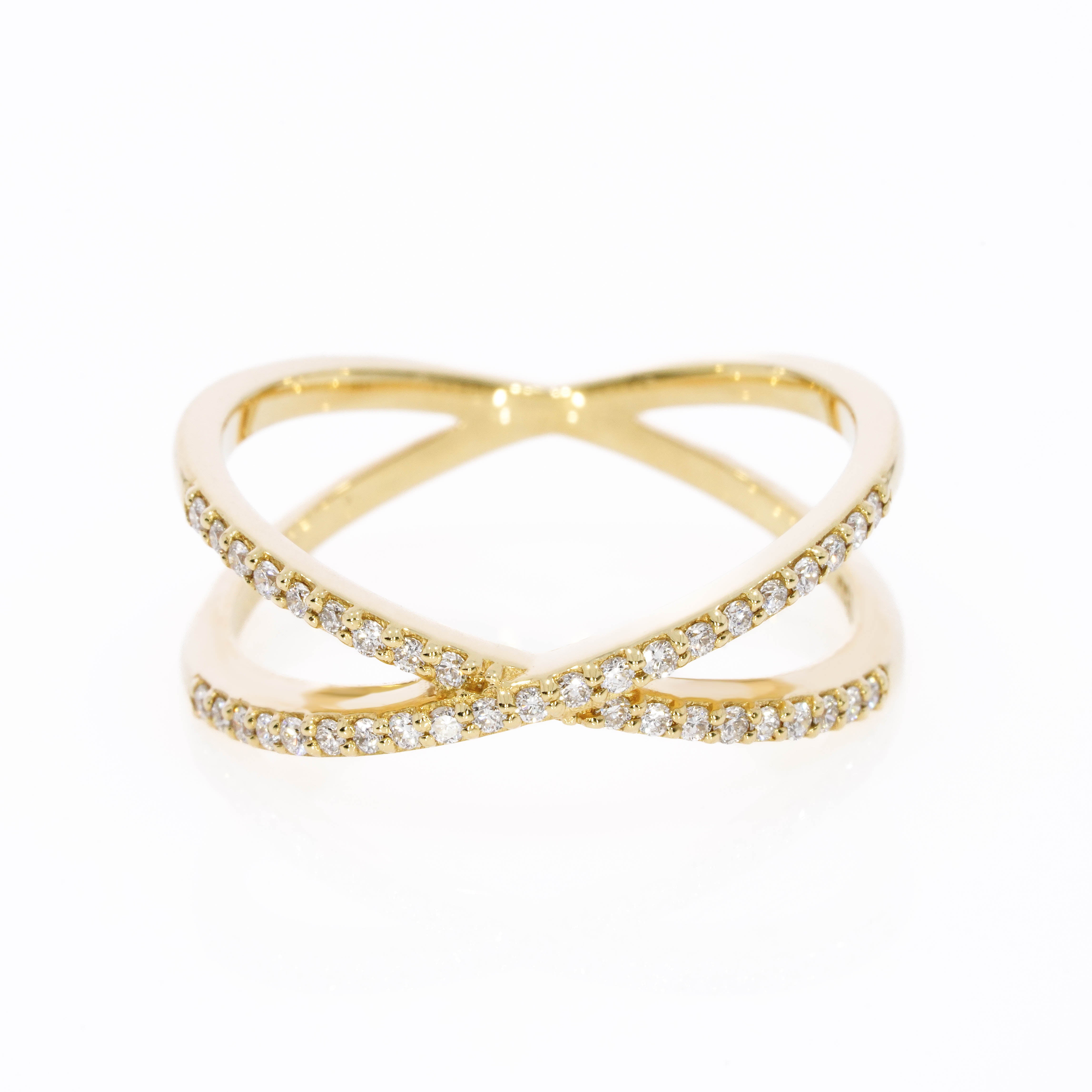 Small criss-cross ring with 0.18cts of bright diamonds, in 18ct gold with stylish bands intersect for a sparkling look.