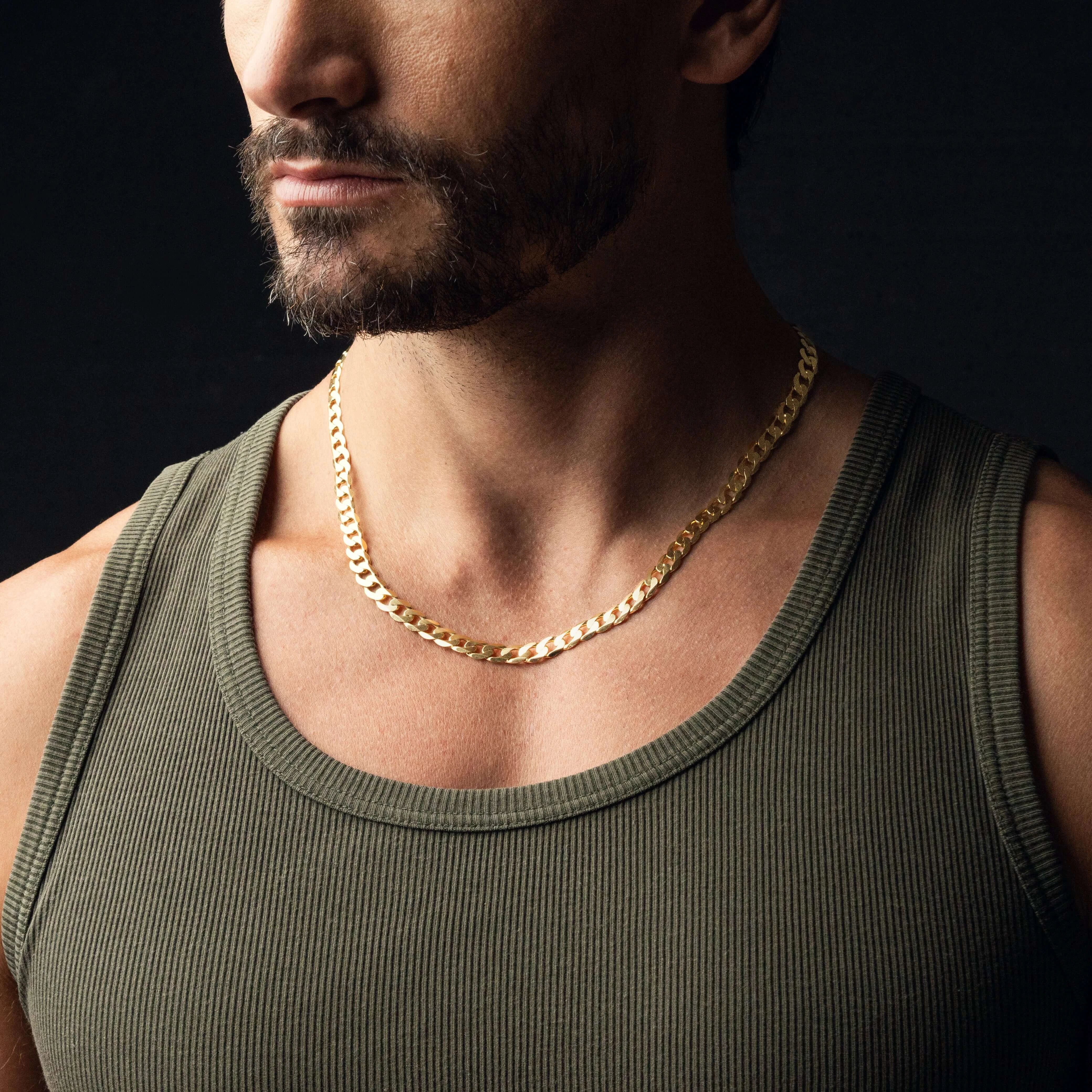 Man wearing a stylish Curb Chain made of solid 18ct yellow gold, showcasing fine jewellery.