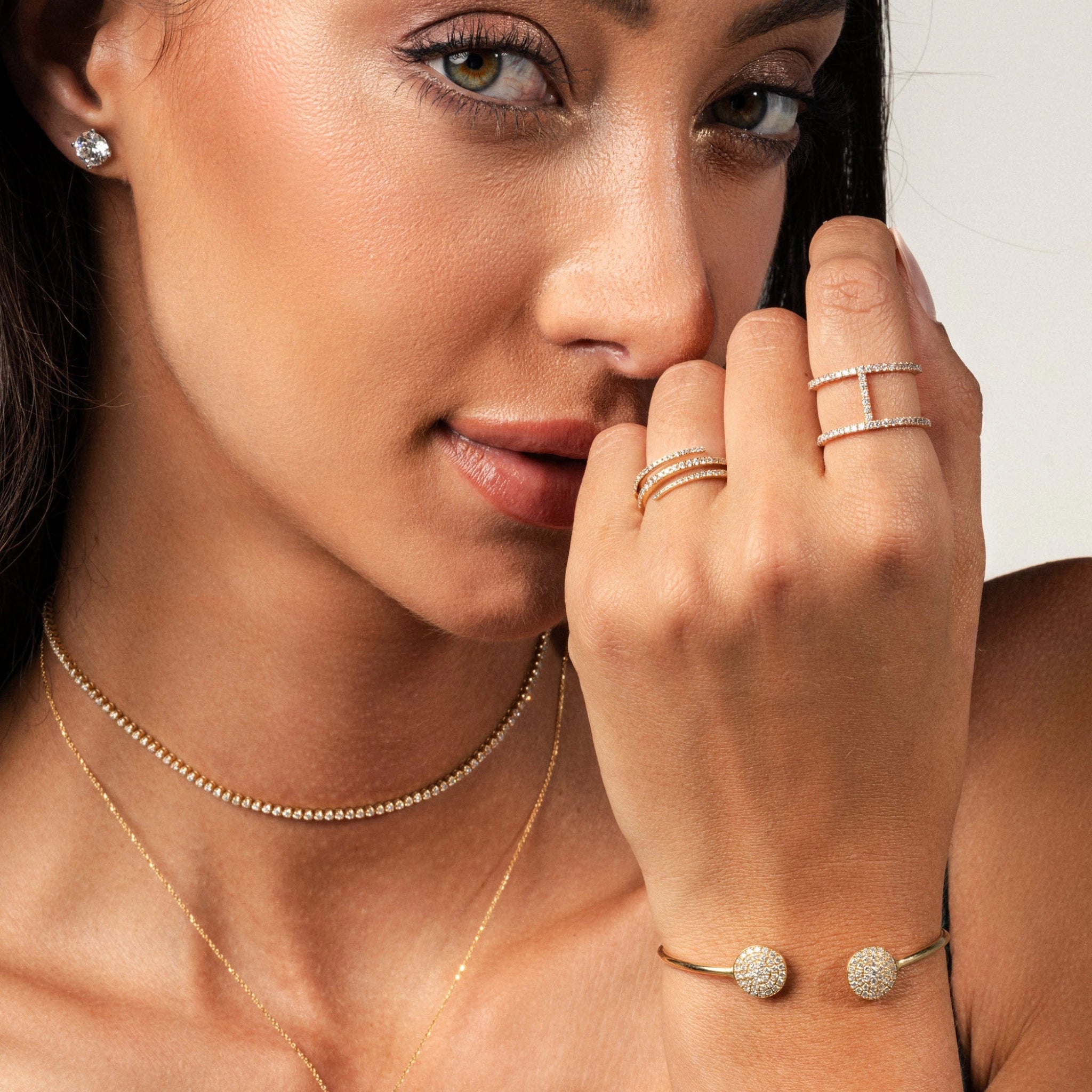 Model showcasing diamond stud earrings and delicate gold jewellery, highlighting certified diamond elegance.