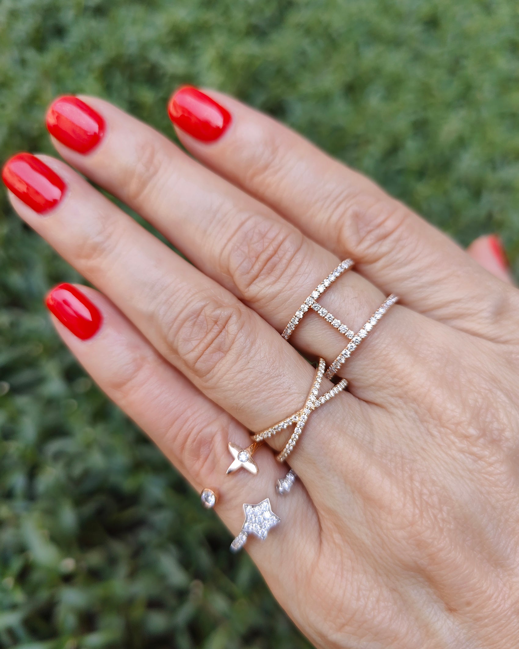 Hand adorned with multiple elegant diamond rings showcasing modern fashion and sparkle.