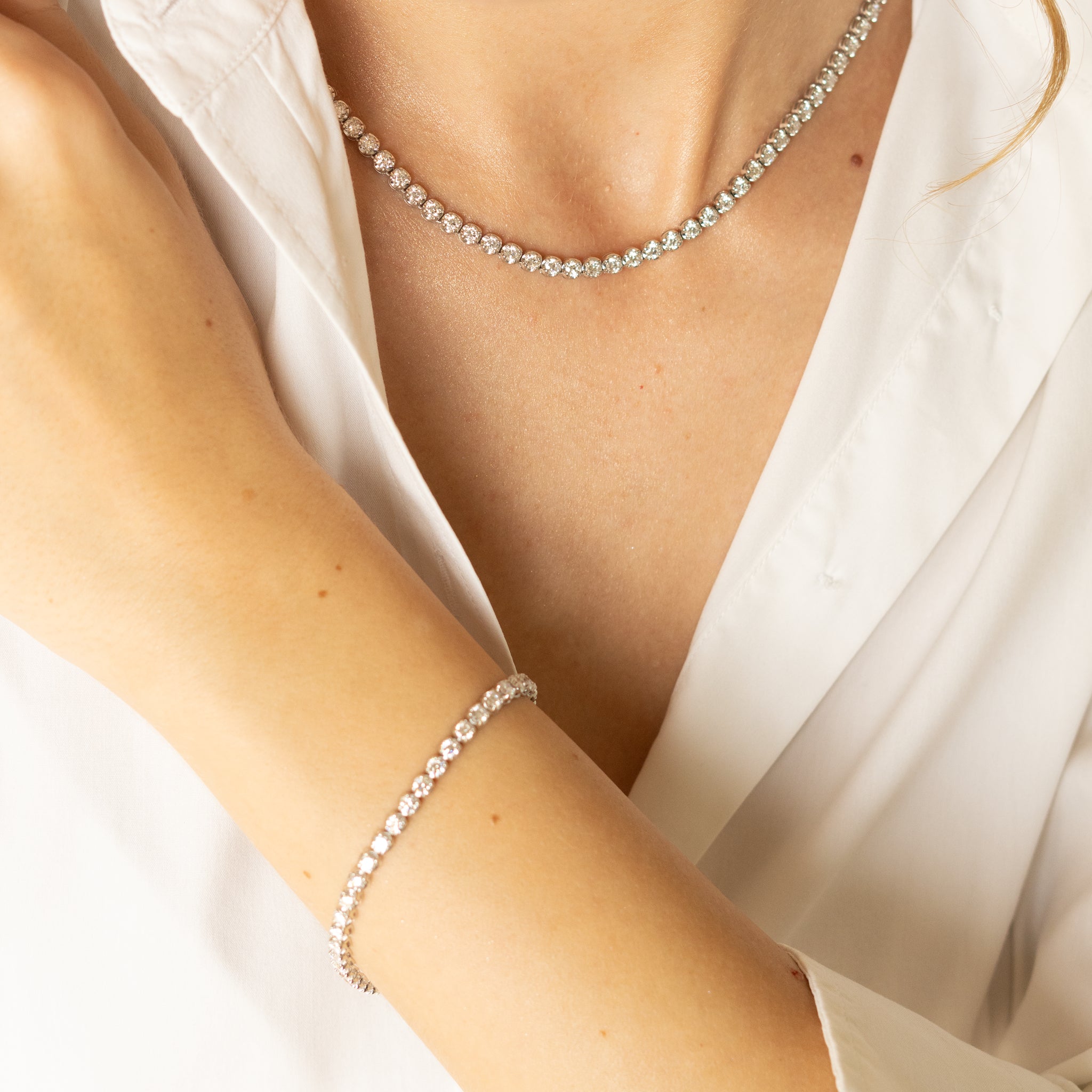 Elegant diamond tennis bracelet nd necklace featuring diamonds for exceptional sparkle and quality.