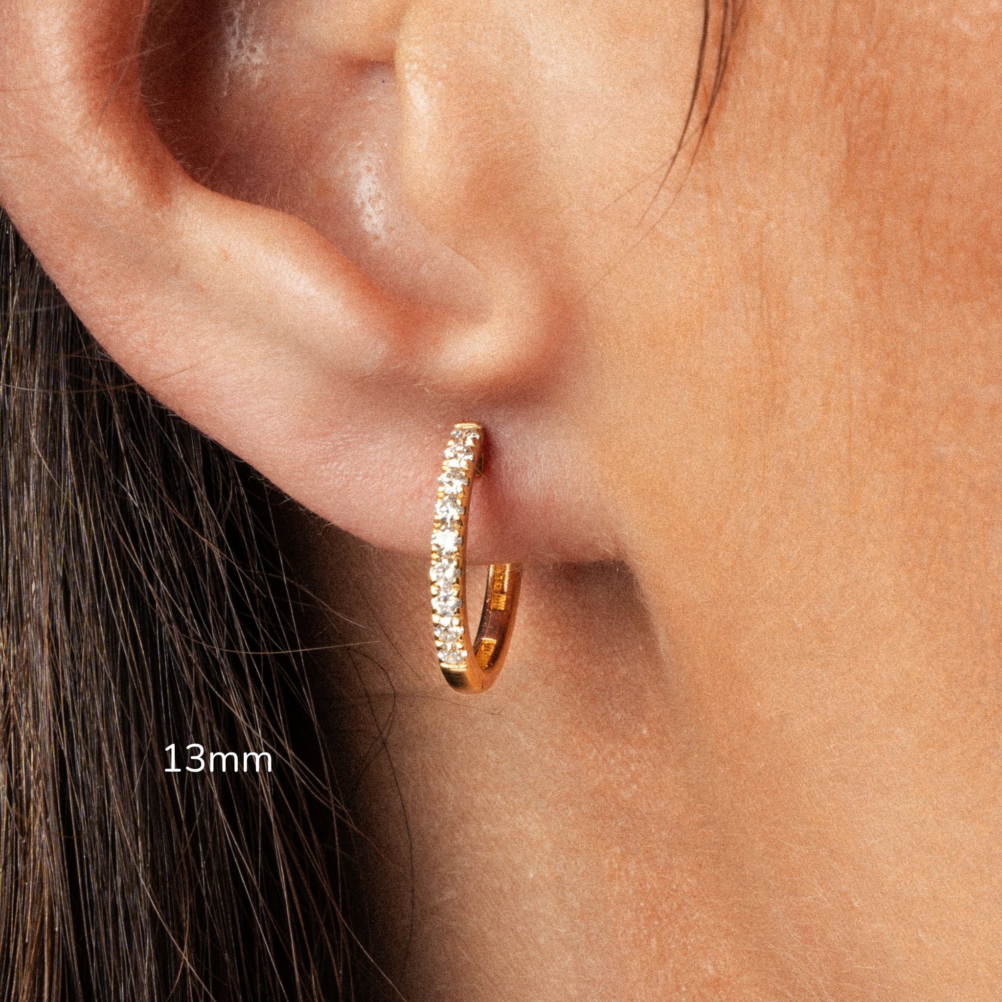 Elegant 13mm diamond hoop earring showcased in a close-up, featuring sparkling certified diamonds in a gold setting.