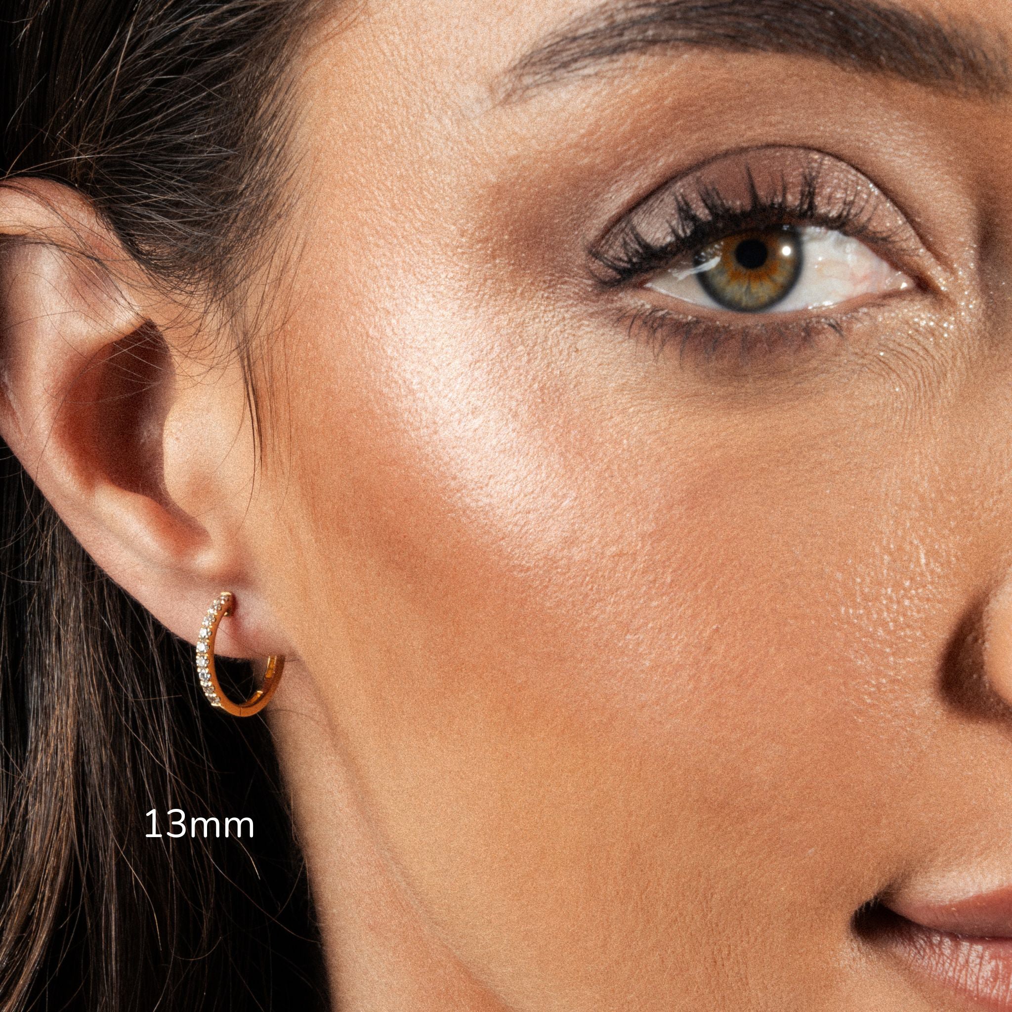 Close-up of model wearing 13mm diamond hoop earring, showcasing elegance and brilliance.