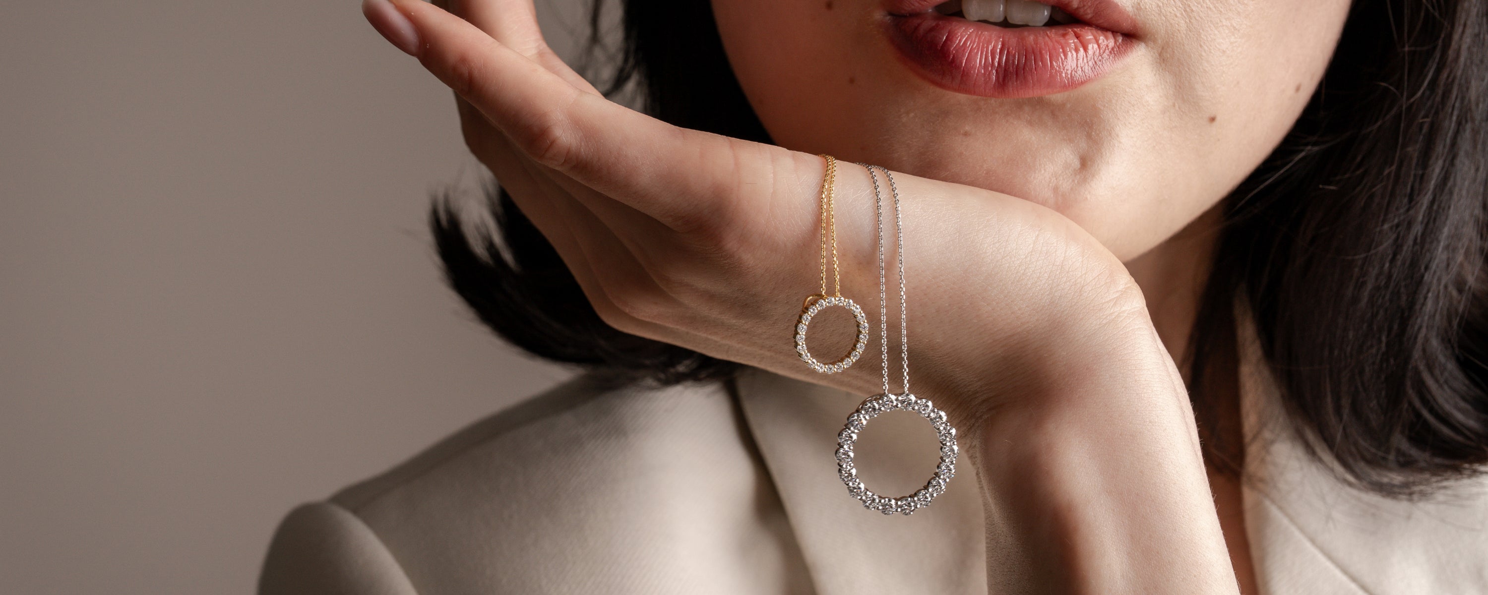 Model showcasing two circle diamond necklaces