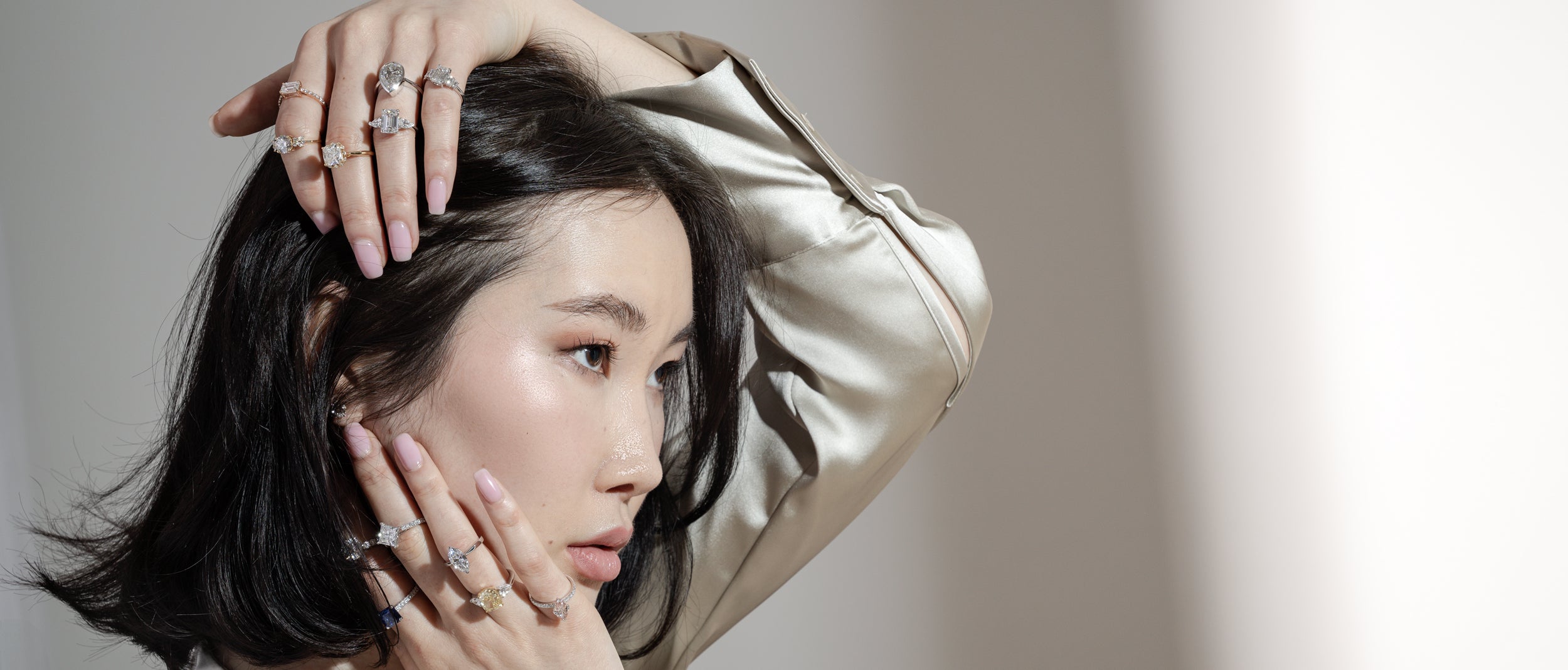 Woman wearing multiple bespoke diamond engagement rings