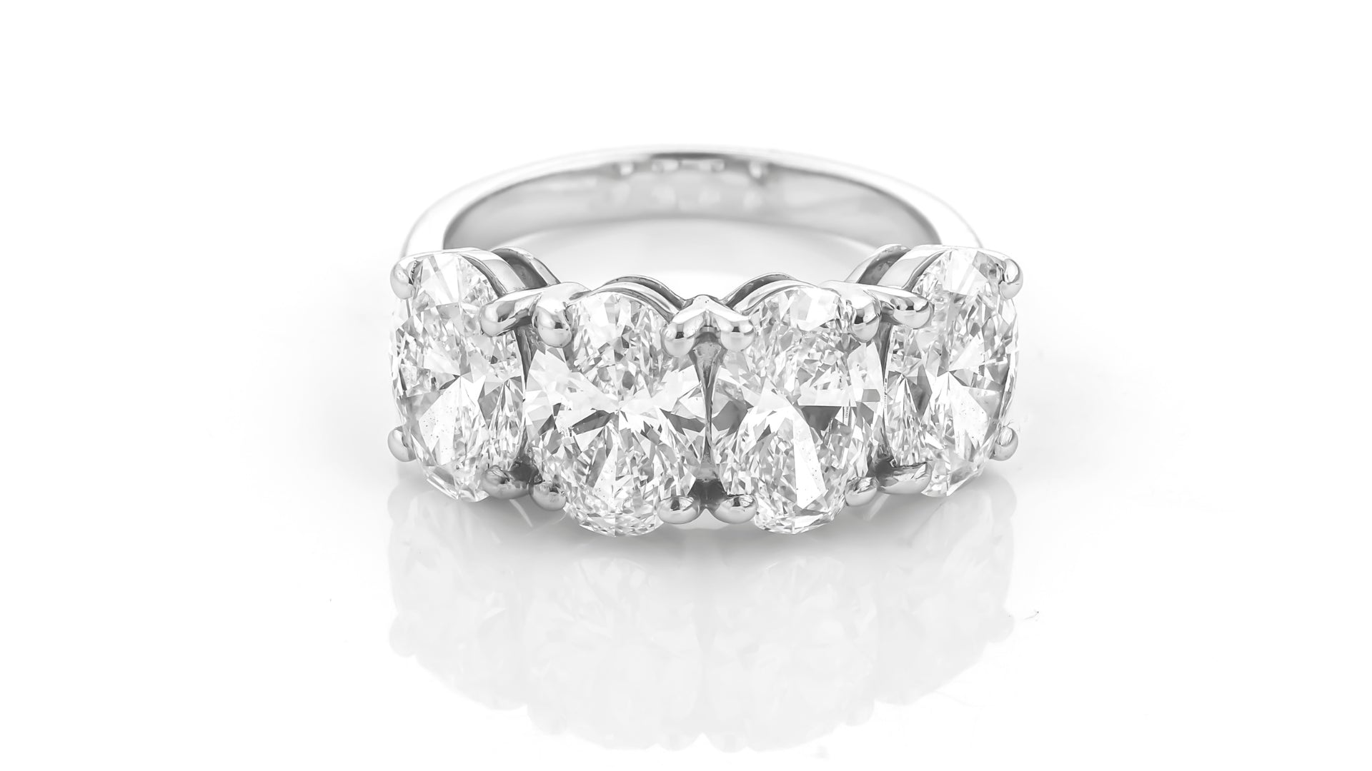 Diamond eternity ring with multiple oval diamonds on a white background