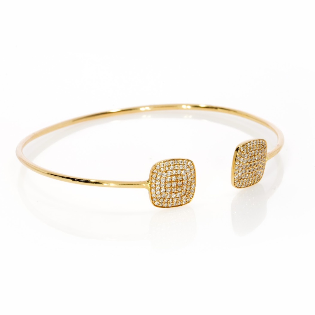 Elegant gold diamond bangle featuring certified diamond clusters in square designs, shining beautifully on the wrist.