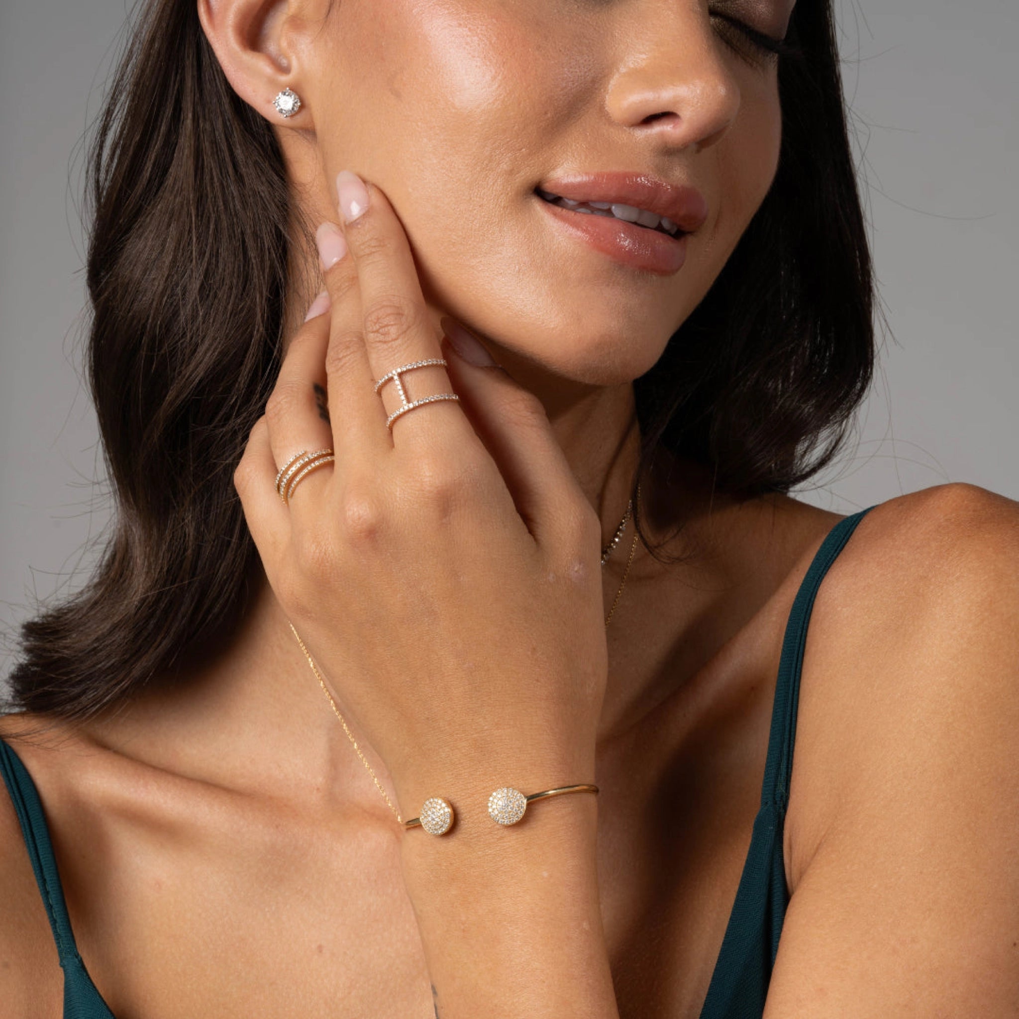 Elegant model showcasing a certified diamond bracelet and rings, radiating sophistication with sparkling accessories.