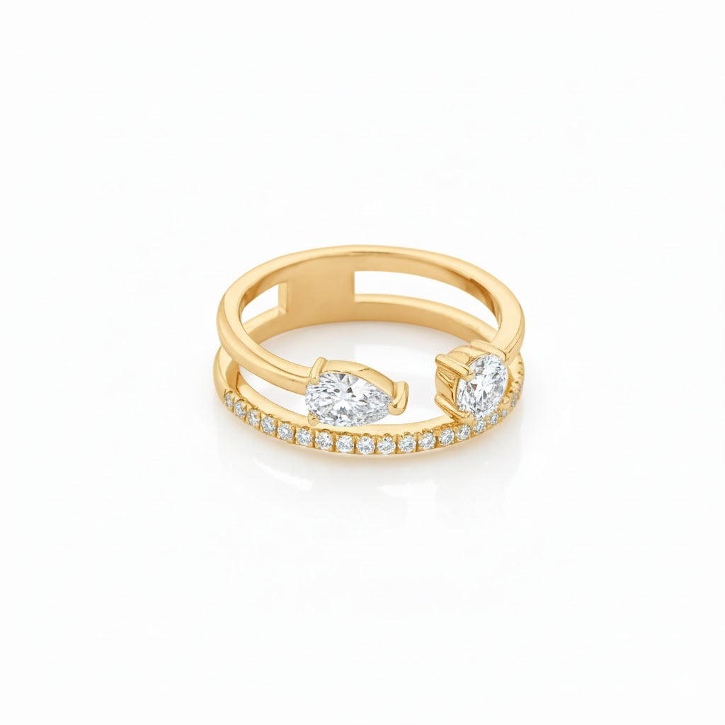 Double Band Gemini Ring in 18ct gold featuring pear and round diamonds with pavé setting, 0.71 total carat weight.