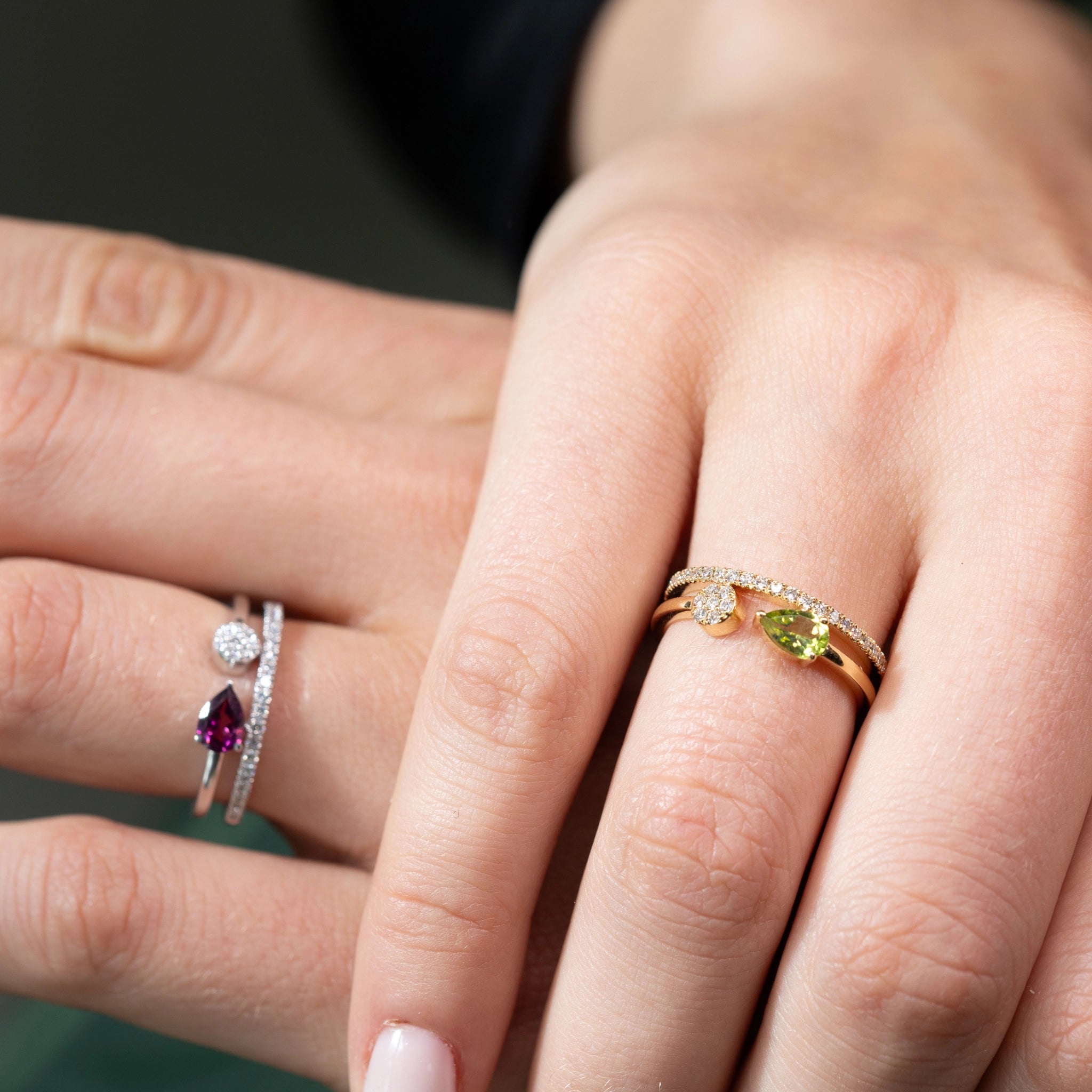 Double Band Gemini Ring featuring pear and round brilliant diamonds on a stylish hand.