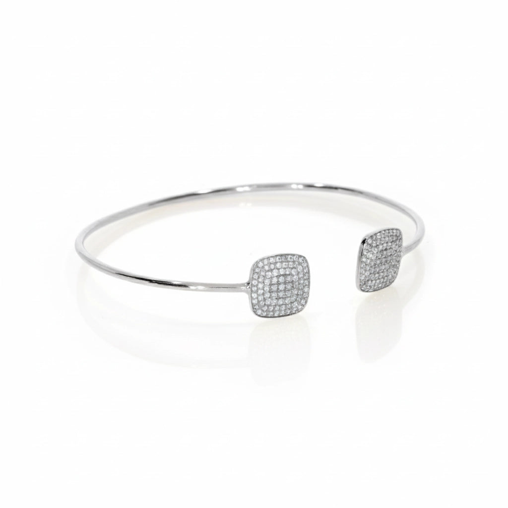 Elegant white gold diamond bangle featuring certified diamond clusters in square designs, shining beautifully on the wrist.