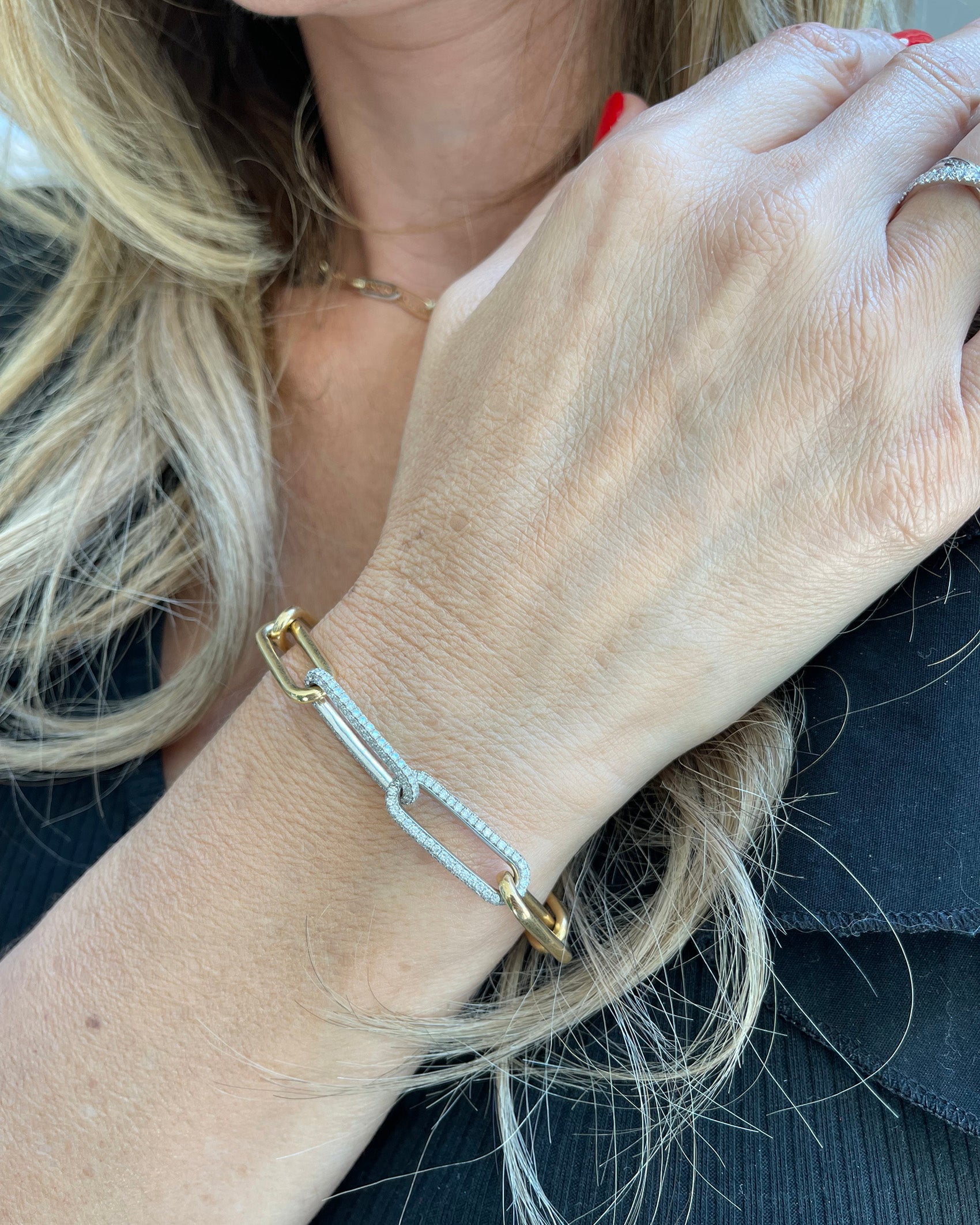 Elegant medium chain link bracelet in yellow and white gold, adorned with sparkling diamonds.