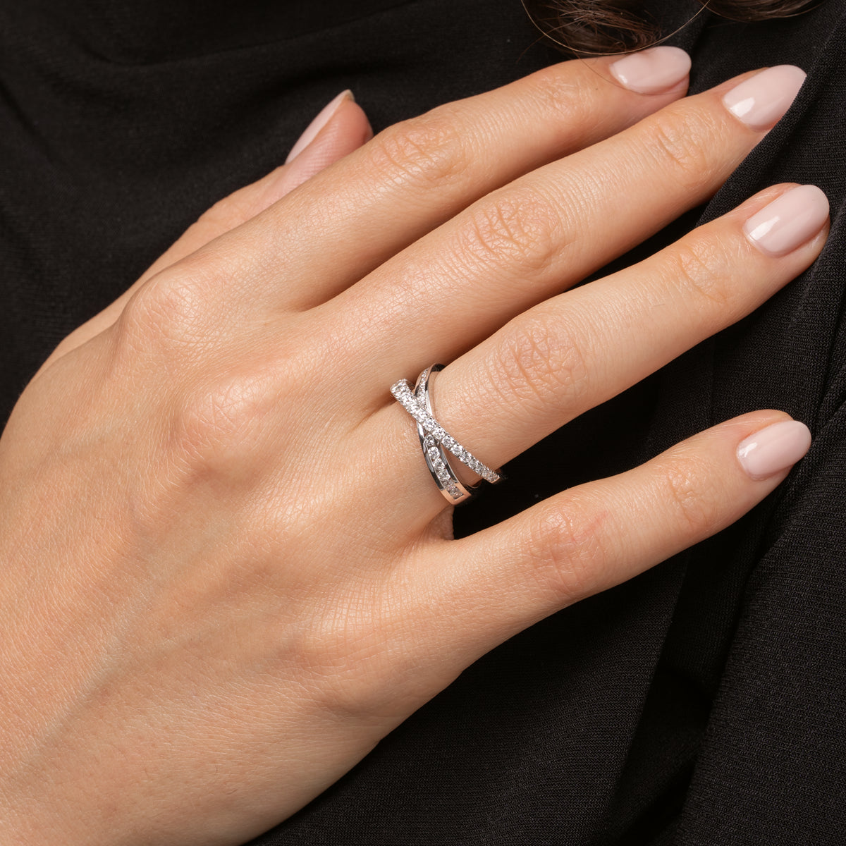 Elegant diamond ring set in 18ct gold, featuring intersecting bands adorned with bright white diamonds.