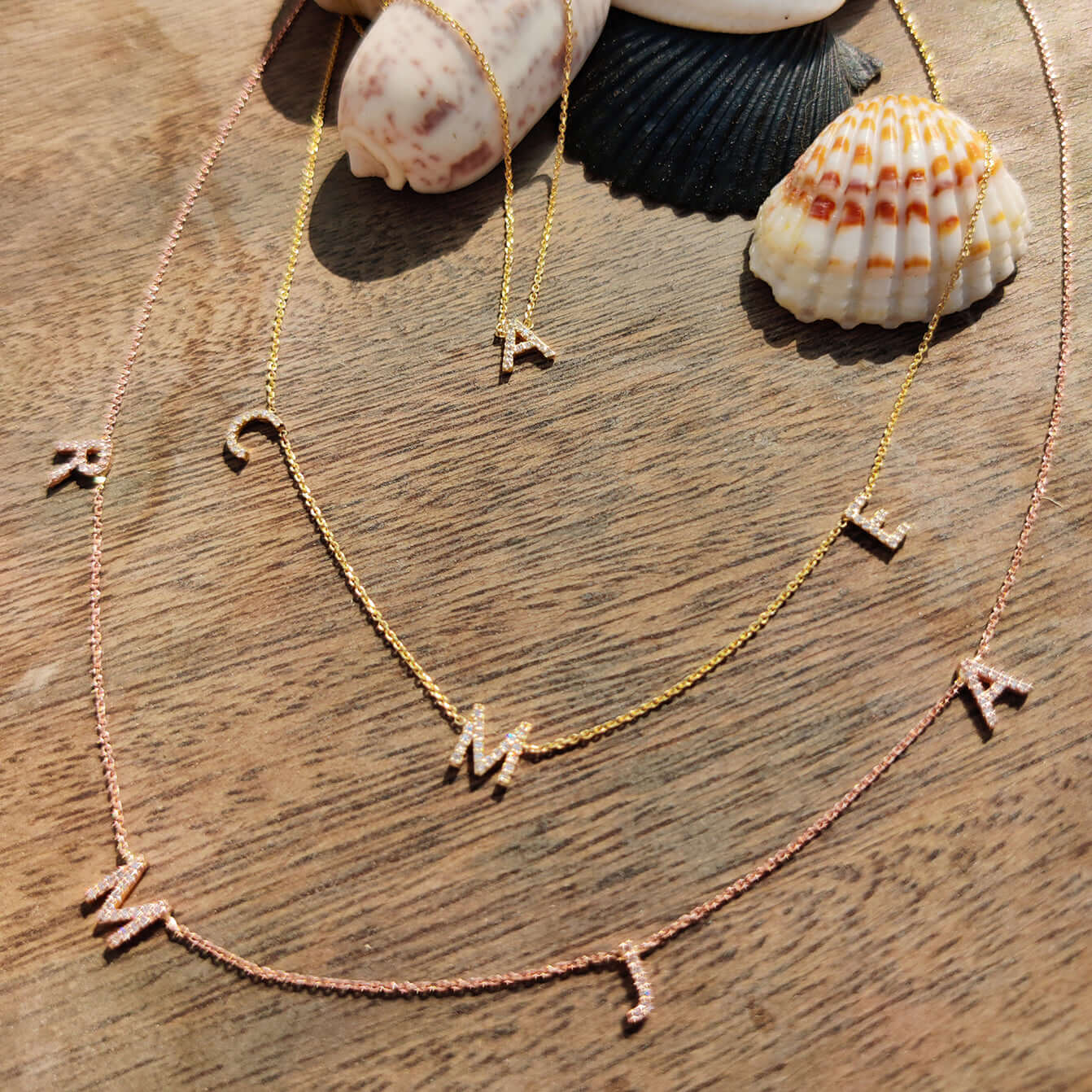 Love Letter necklace showcasing initials in 18ct gold with natural diamond accents on a fine link chain.