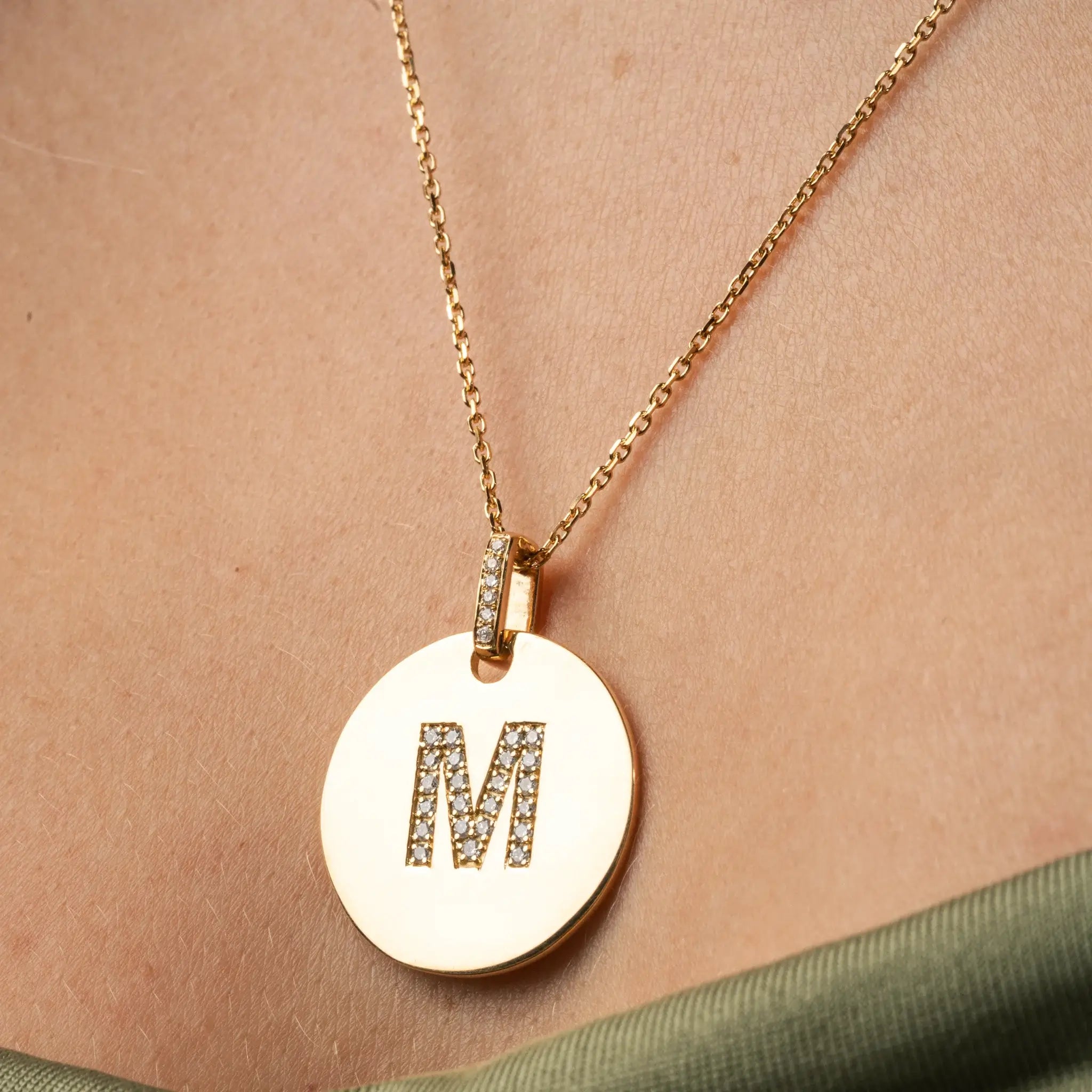 Love Letter Disk necklace featuring an 'M' initial in certified diamonds, crafted in 18ct gold.