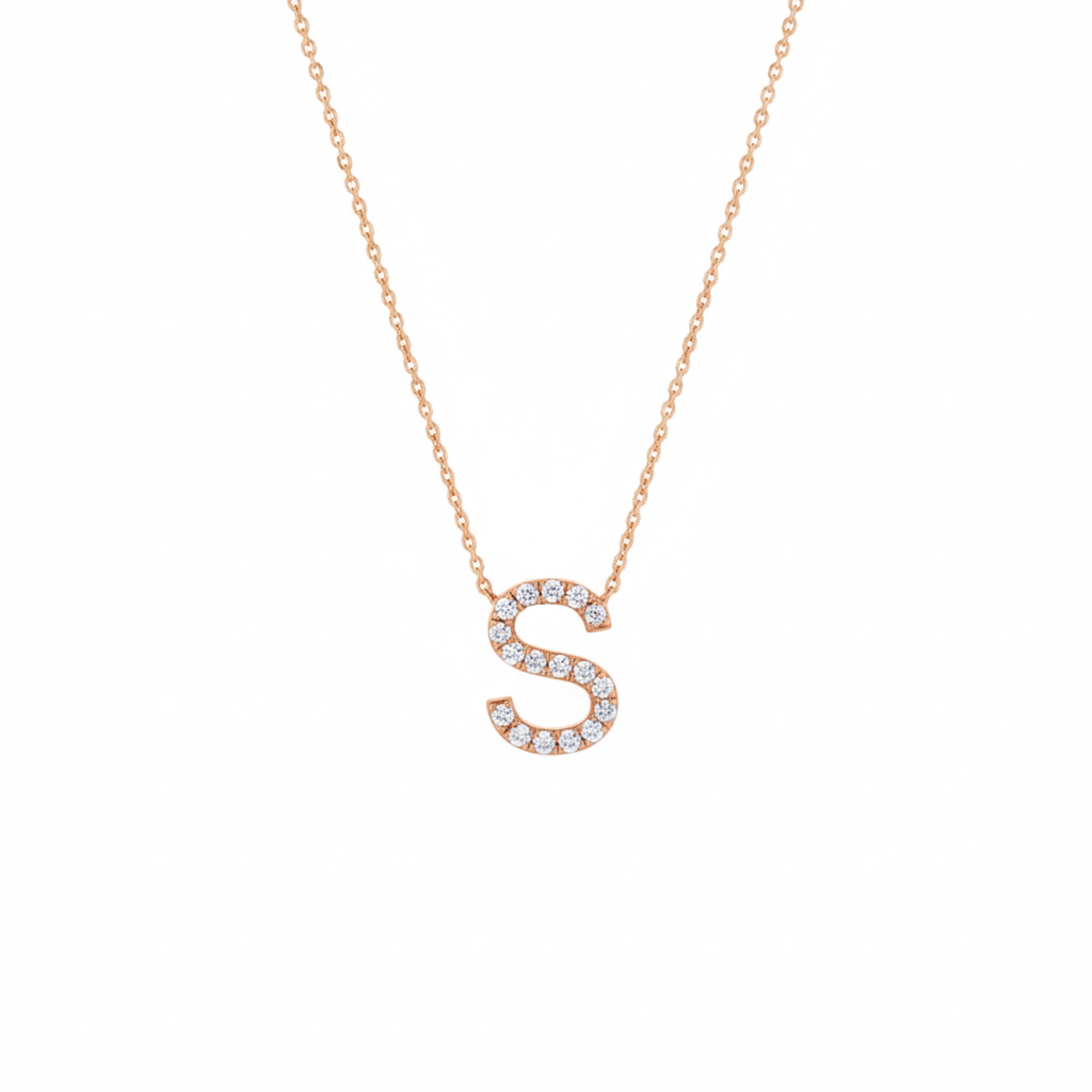 Rose gold necklace with a letter 'S' pendant on a white background