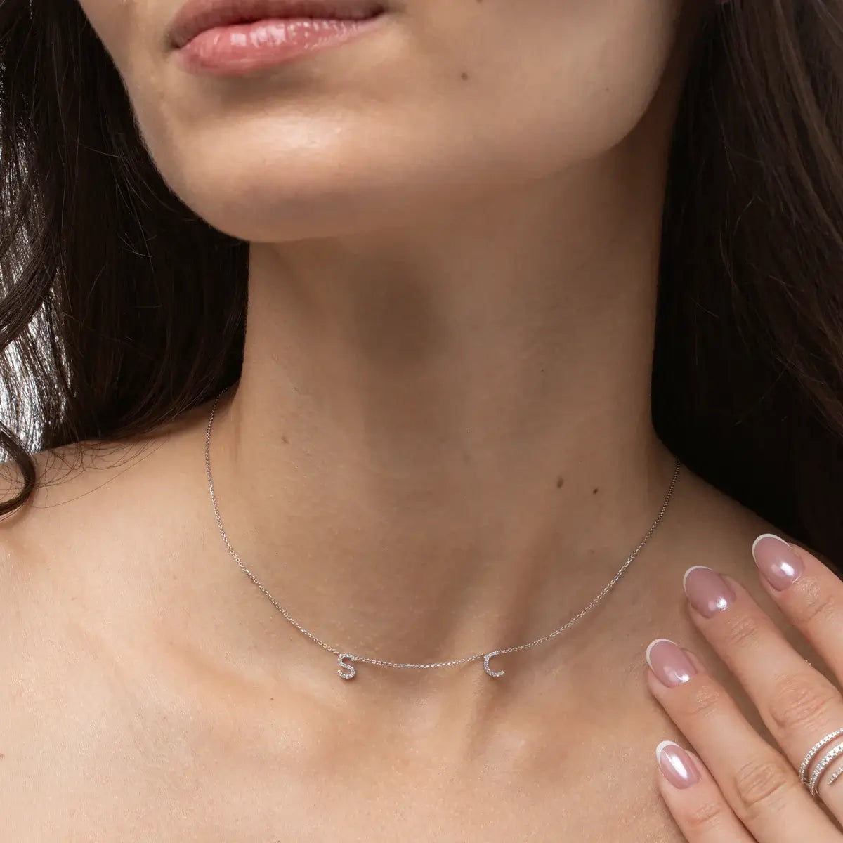 Model wearing Love Letter necklace with personalised initials and natural diamond details on a fine chain.