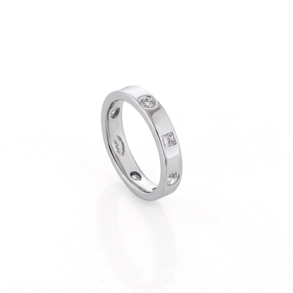 White gold ring with embedded diamonds on a white background