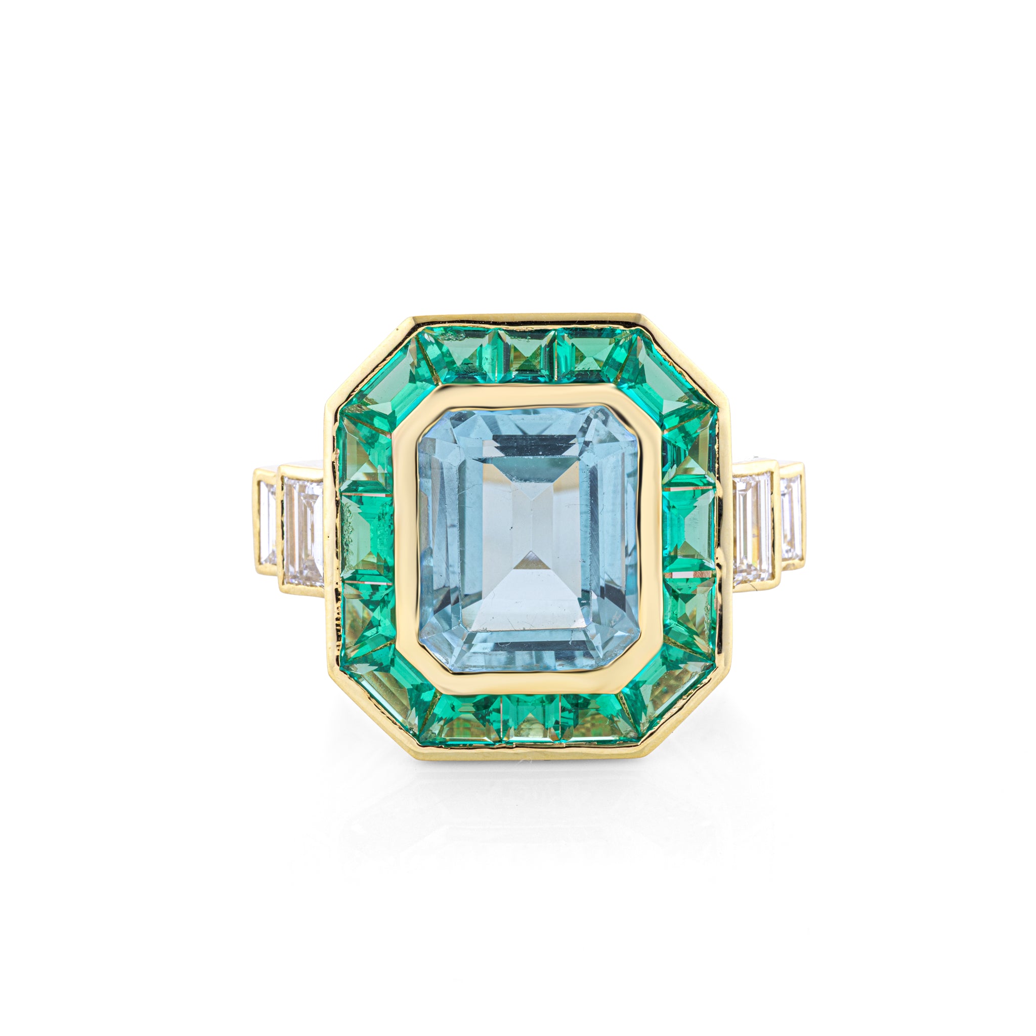 An octagonal yellow gold ring featuring a large emerald cut light blue topaz center stone, surrounded by a halo of green emerald cut diamonds, with small baguette-cut side diamonds on the band, set against a plain white background.