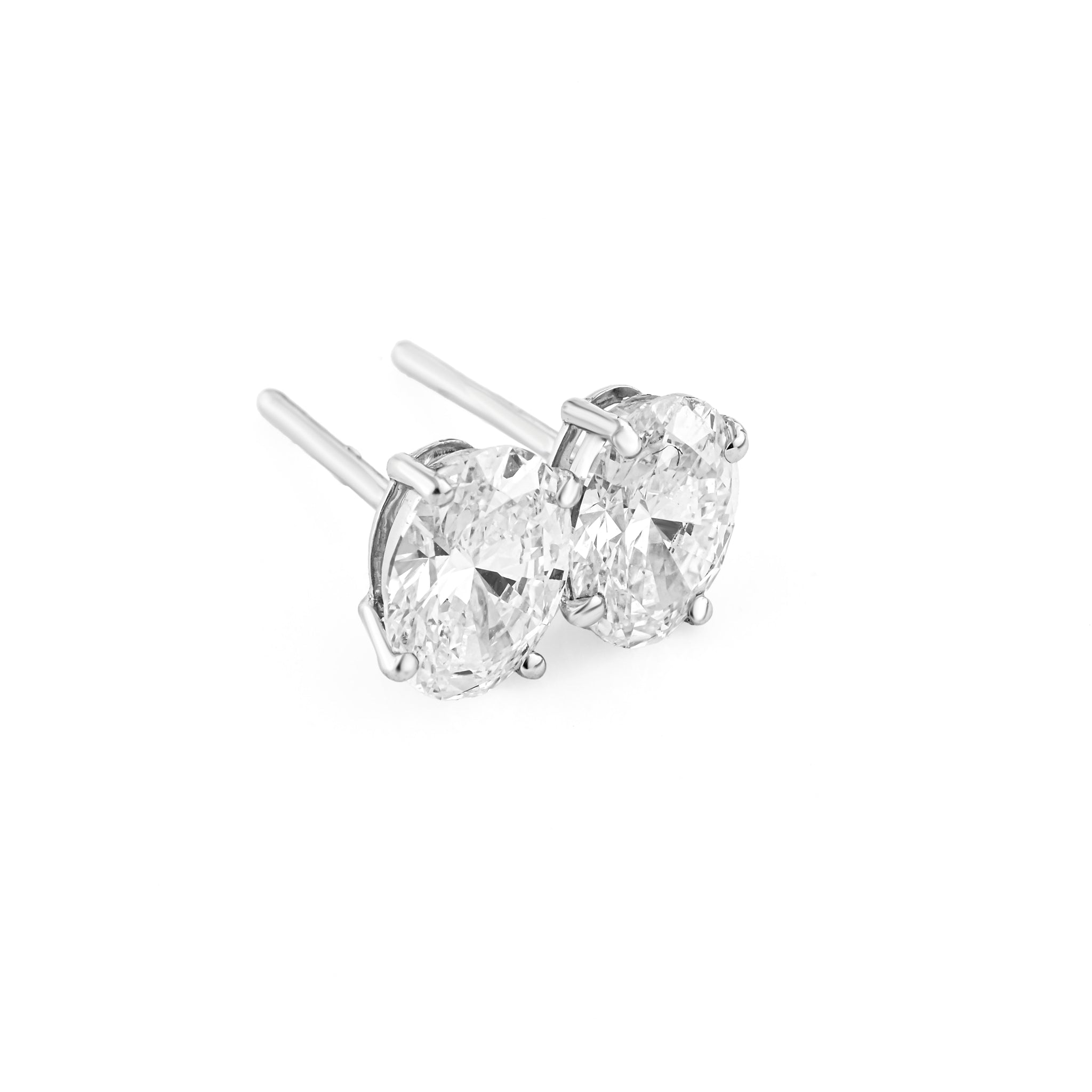 Pair of diamond stud earrings on a white background