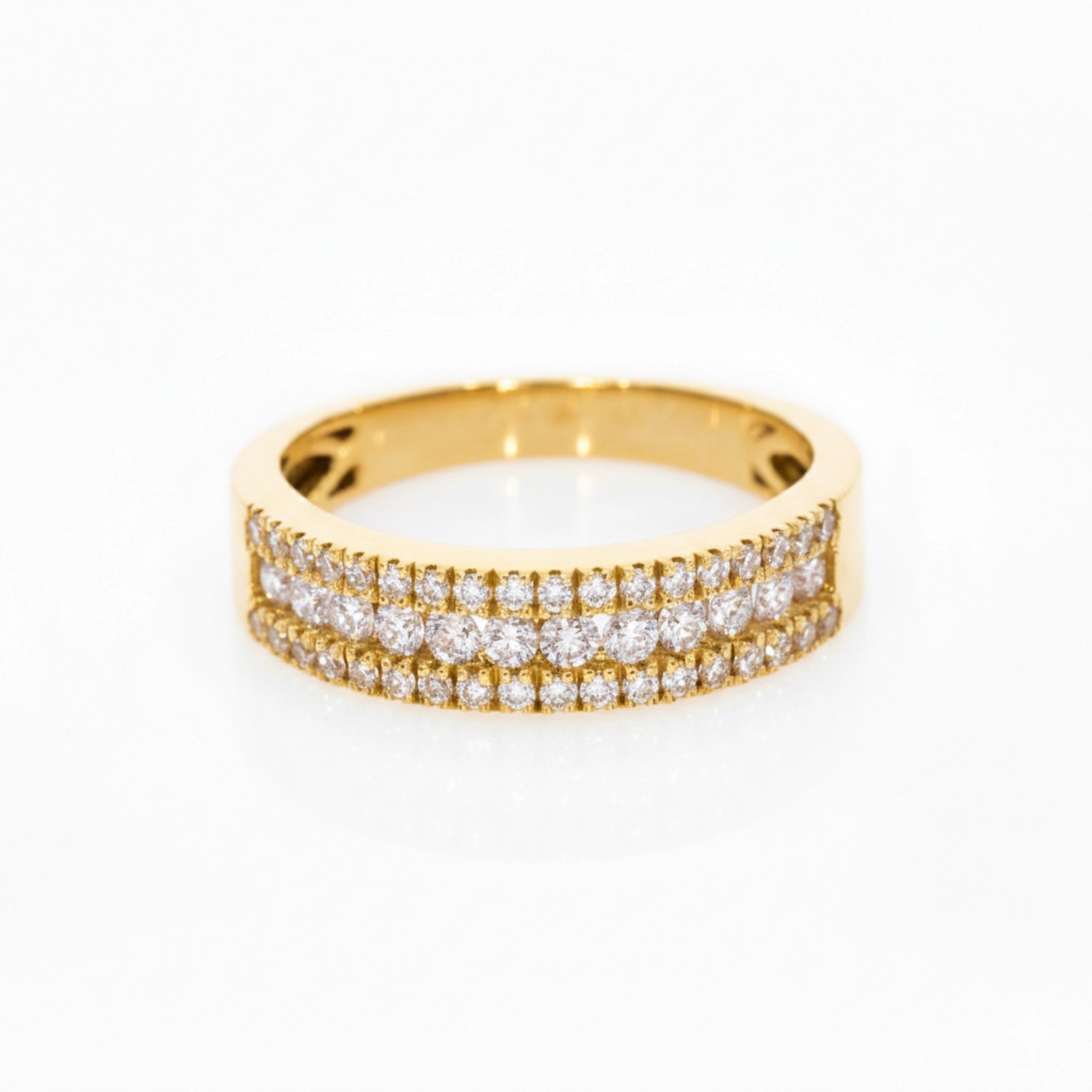 A delicate three-row pave diamond ring with 0.57cts diamonds, set in 18ct gold for optimal brilliance.