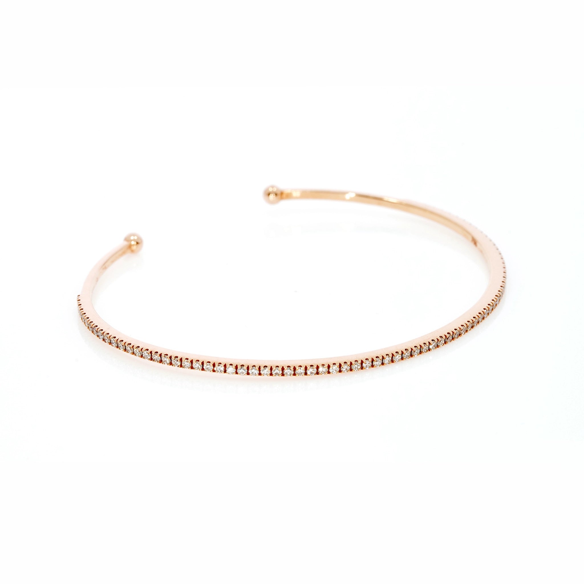 Elegant push-on tennis bangle in 18ct gold featuring diamonds, ideal for stacking with other bracelets.