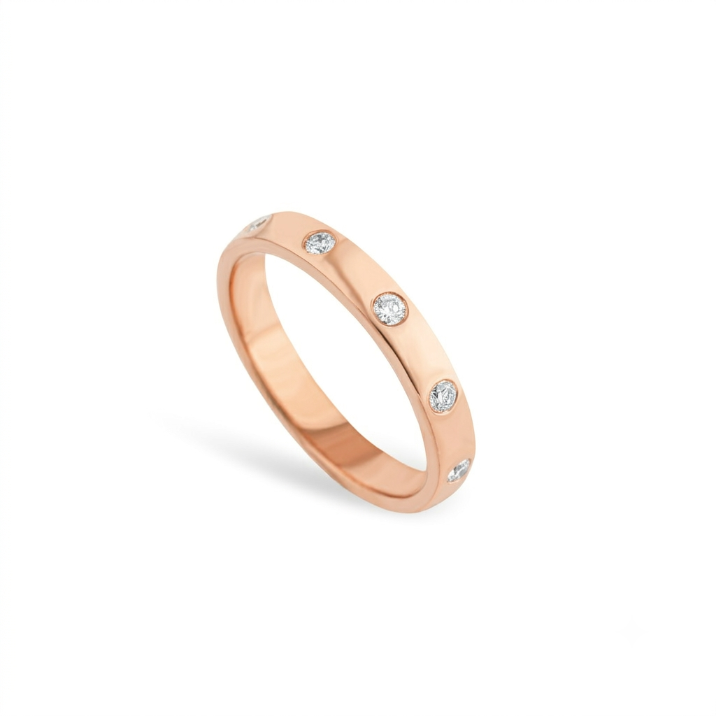 A rose gold band ring featuring round cut diamonds shown on a clean white background.