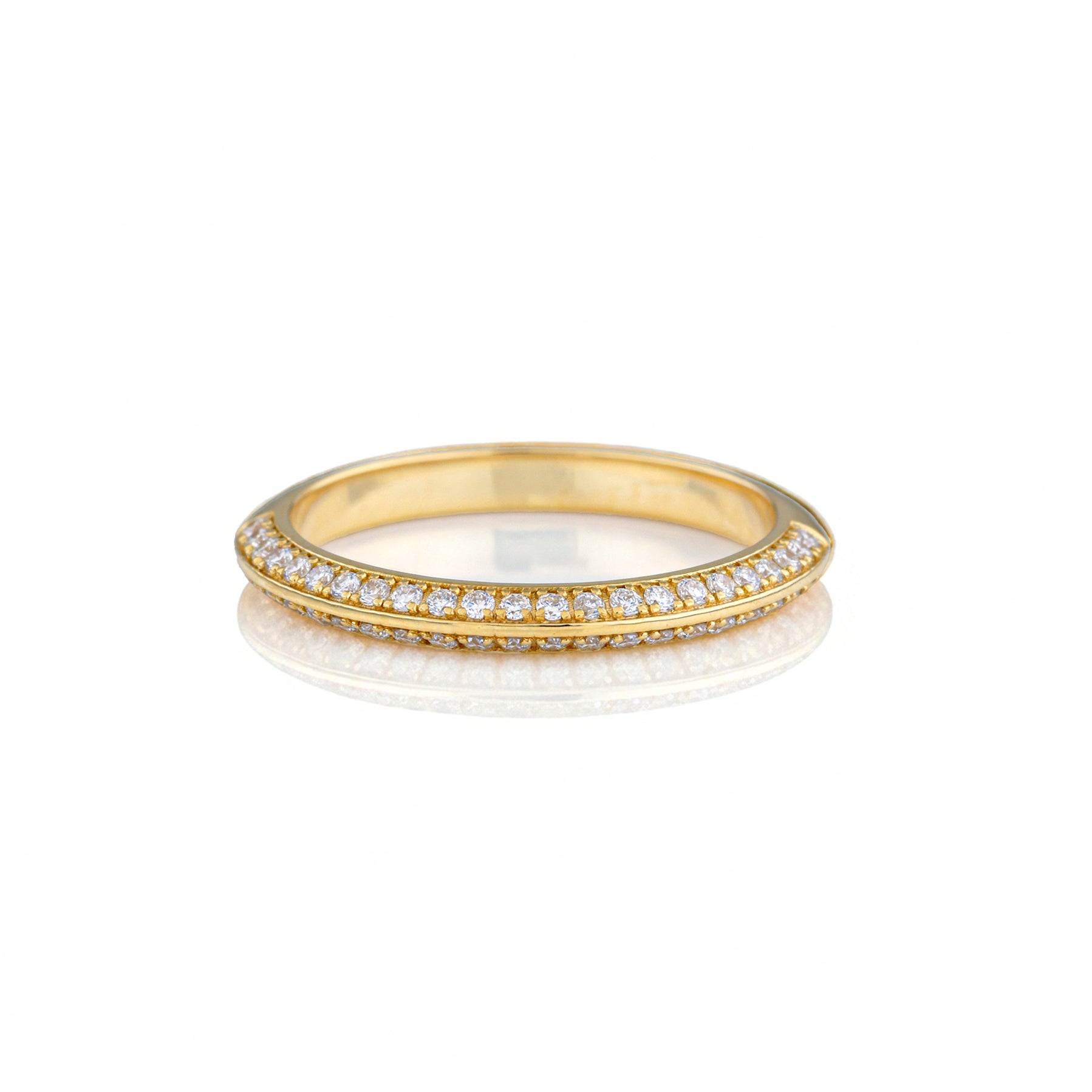 Knife Edge Wedding Band with pavé set diamonds reflecting light in a luxurious gold setting.