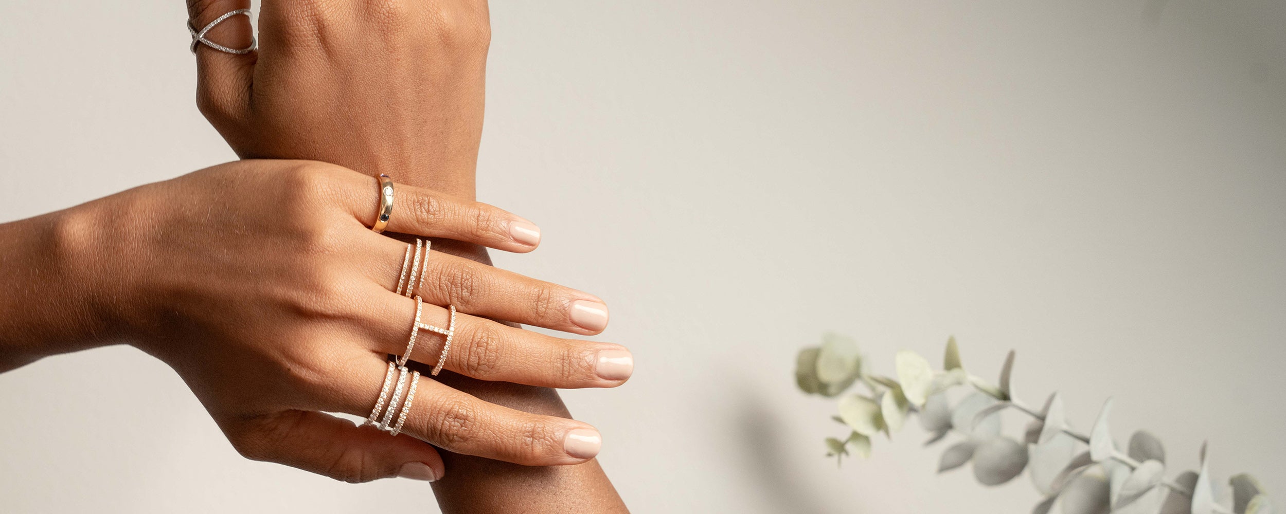 Elegant hands adorned with diamond fine jewellery rings showcasing craftsmanship and style.