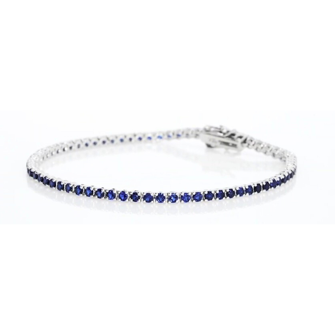 Sapphire tennis bracelet set in 18ct white gold showcasing exquisite violet-blue sapphires from our gemstone tennis bracelet collection.