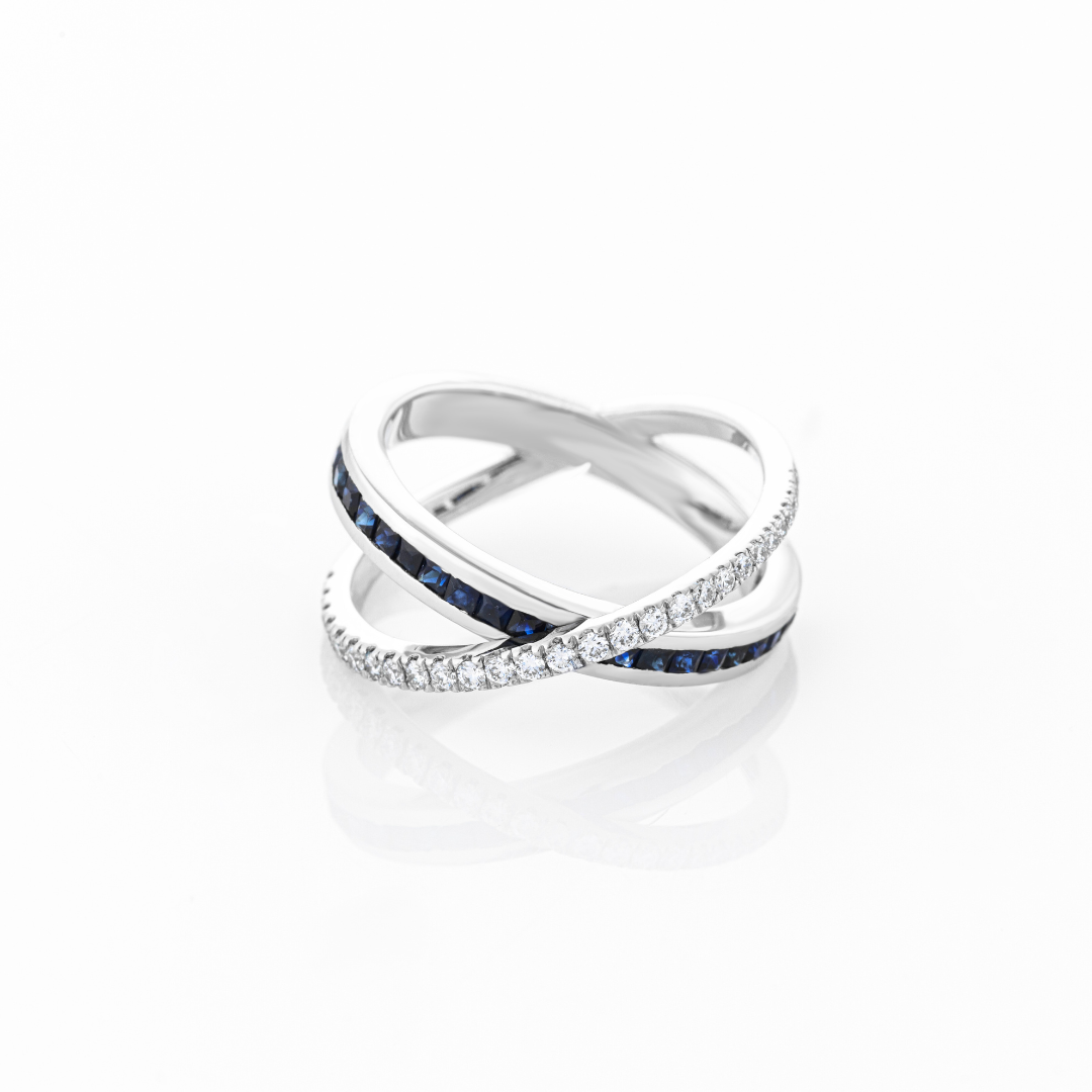 Stunning sapphire criss cross ring showcasing blue sapphires and diamonds set in white gold, a perfect gemstone ring.