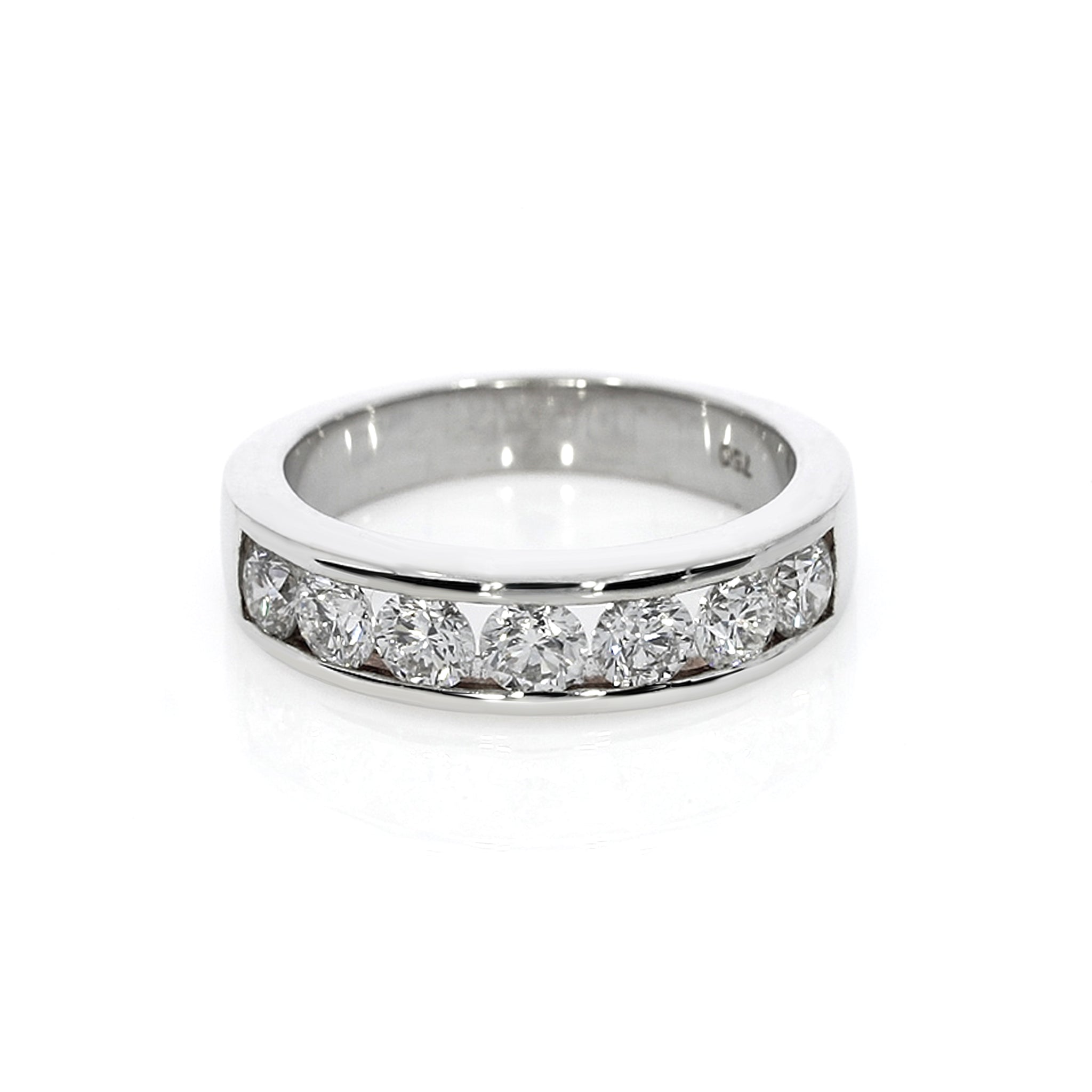 Modern design ring with seven round brilliant cut diamonds in a channel setting.